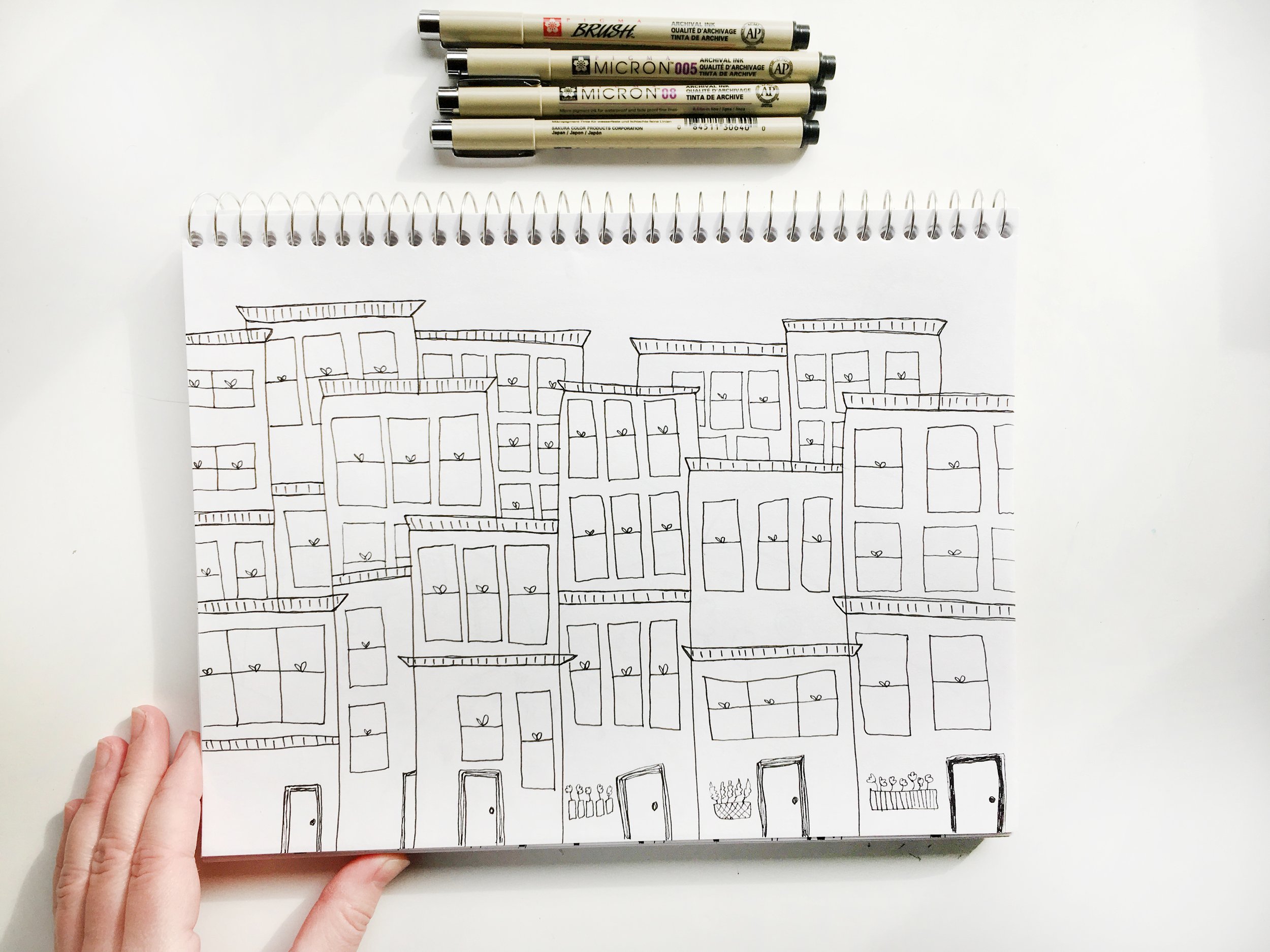 whimsical doodles and drawings by Emma Freeman Art, colorful, happy illustrations done by hand by Emma Freeman Art in Wisconsin, sketchbook artist, learning to draw, meditative drawing, drawing for fun, quirky and whimsical sketchbook drawing of city