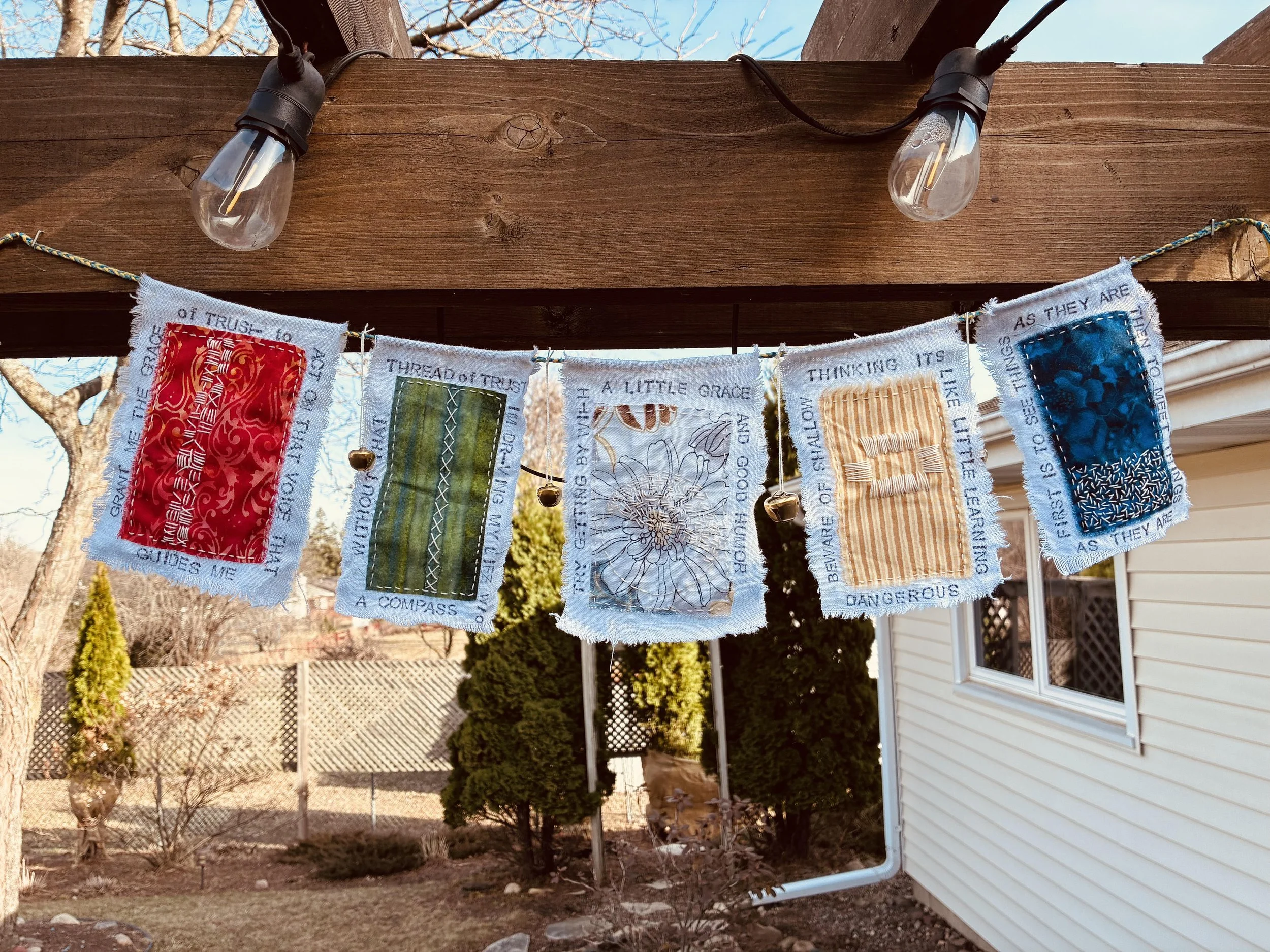 slow stitched prayer flags made with textiles, embroidery and fabric in Emma Freeman's peaceful online art retreat, Wisconsin art retreats, midwest art retreats