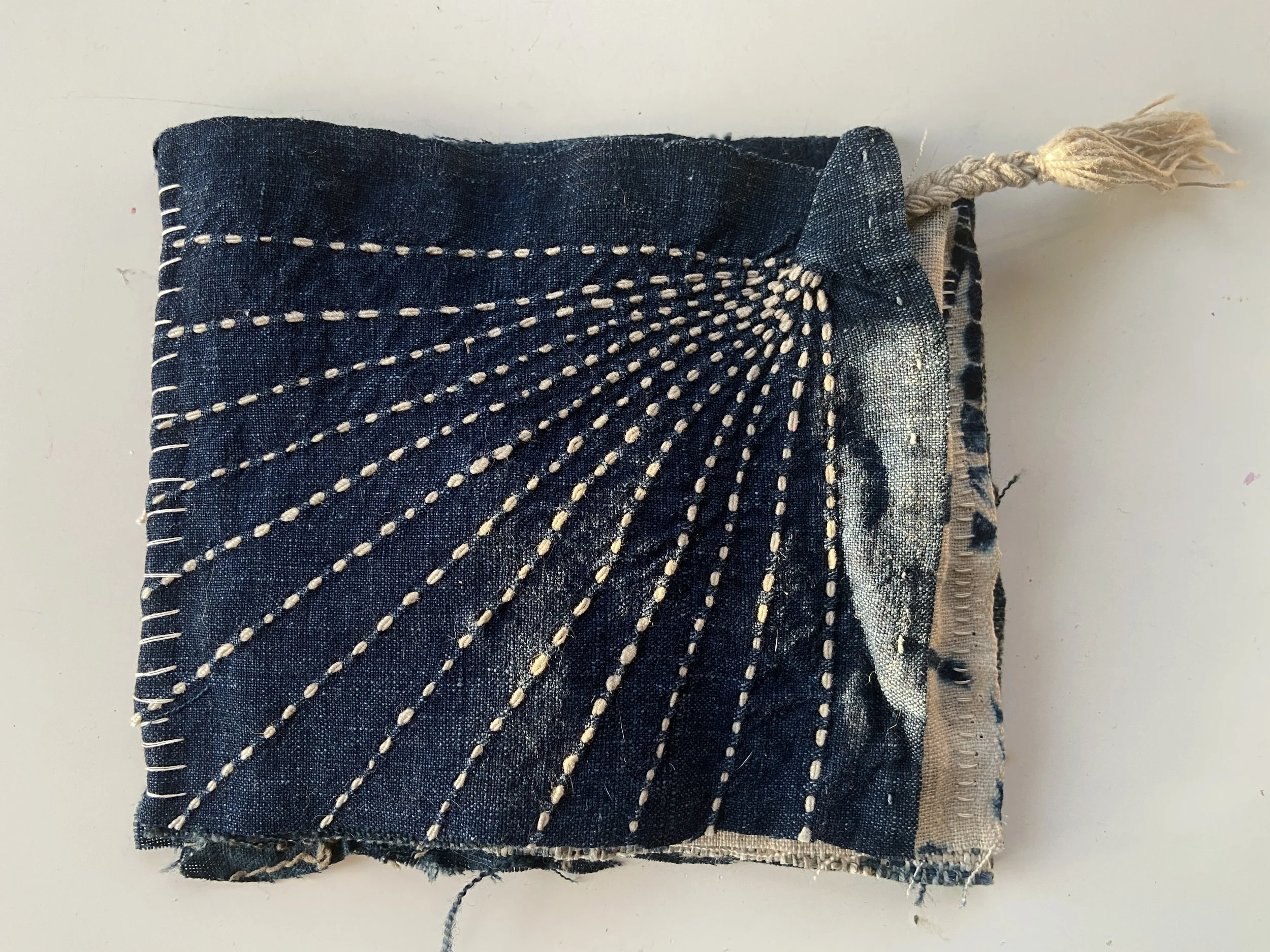 Rustic, wabi sabi mixed media textile books made by Emma Freeman using vintage textiles from Japan and China, naturally dyed fabrics, hand spun nettle yarn from India dyed with indigo, lotus seed meditation bead, and slow stitching by hand. 