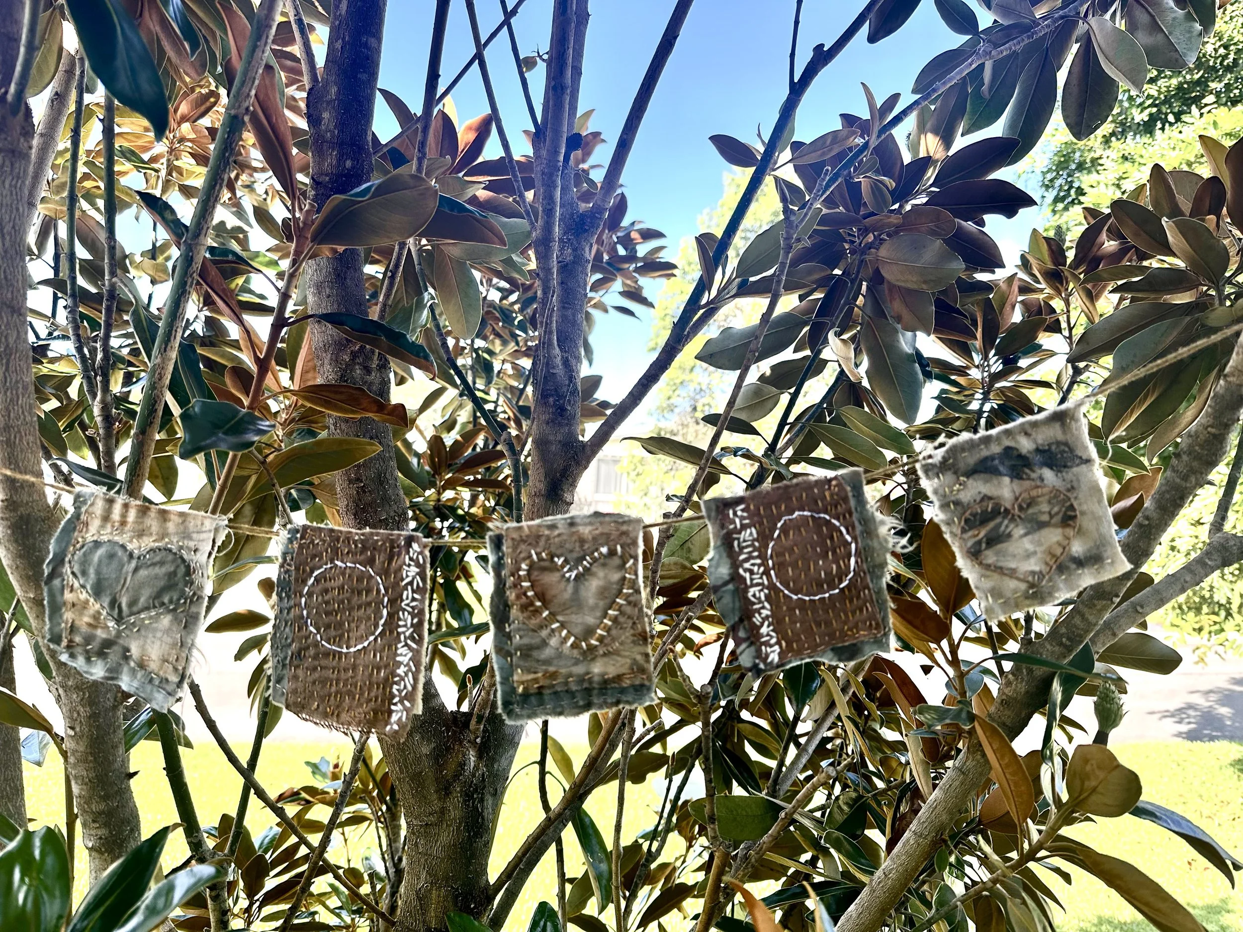 Slow stitched prayer flags made by Krystyna Moore, Australian artist during a peaceful online art retreat with artist, Emma Freeman in Wisconsin. 