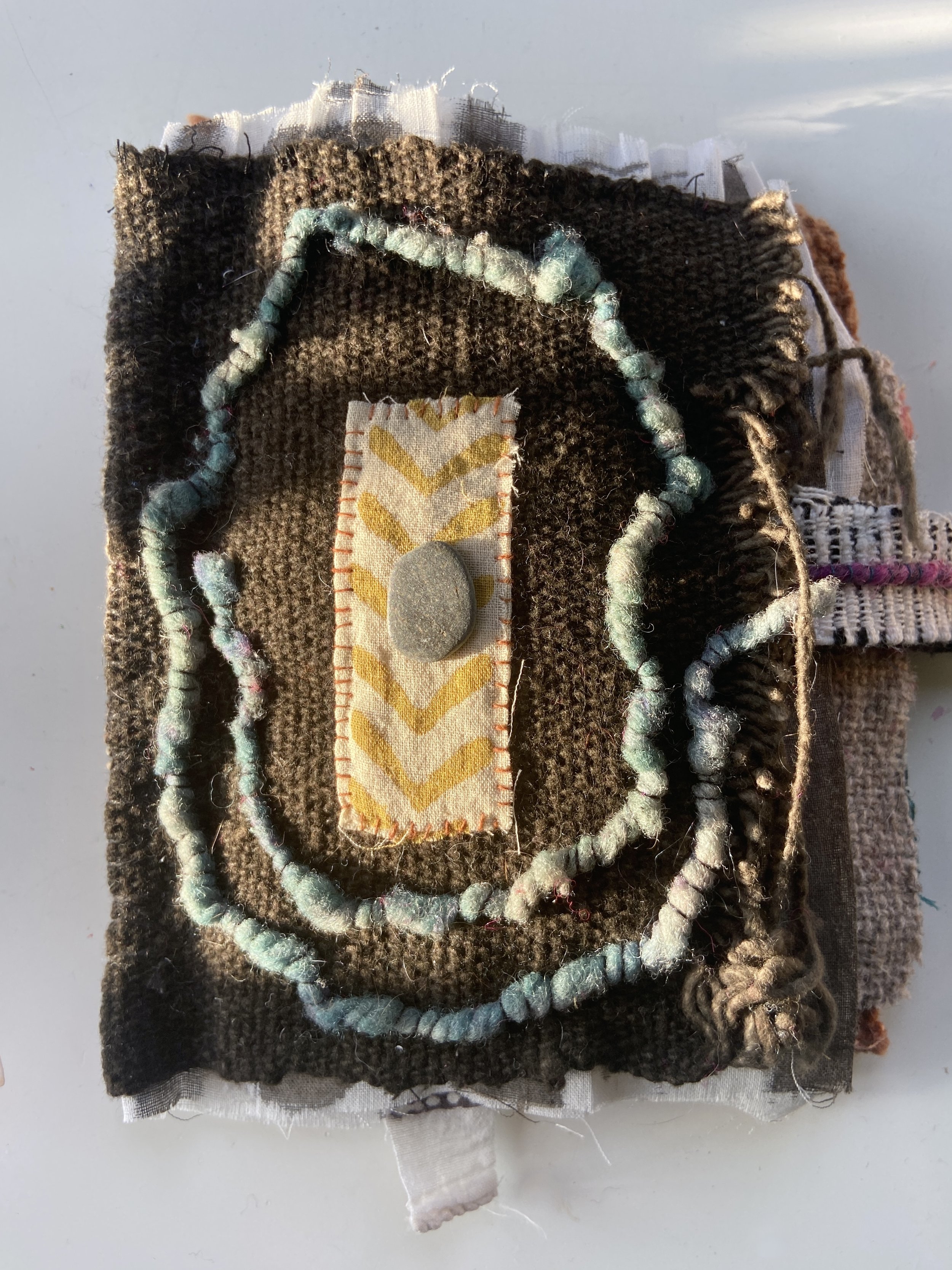 Rustic, contemplative mixed media textile books made by mixed media artist, Emma Freeman using vintage global textiles including mud cloth from Mali in Africa, batik fabric from India, wool yarn from a Peruvian frazada blanket, naturally dyed fabrics
