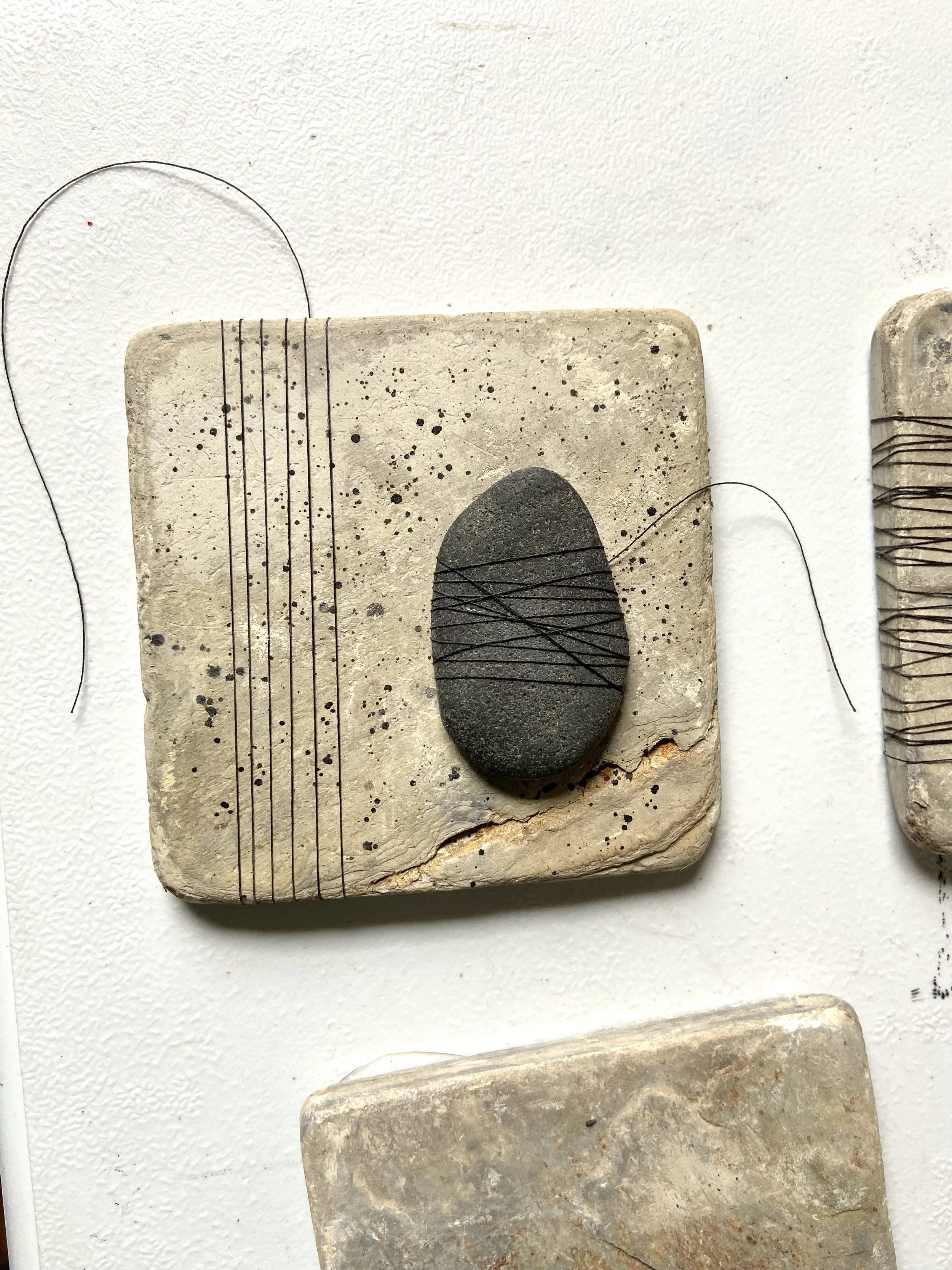 Zen contemplative assemblages of repurposed stone tiles, thread, gathered stones, nature connected art, meditative art, contemplative art, peaceful art, mixed media artist in Wisconsin, Emma Freeman Art, textile artist, art as spiritual practice