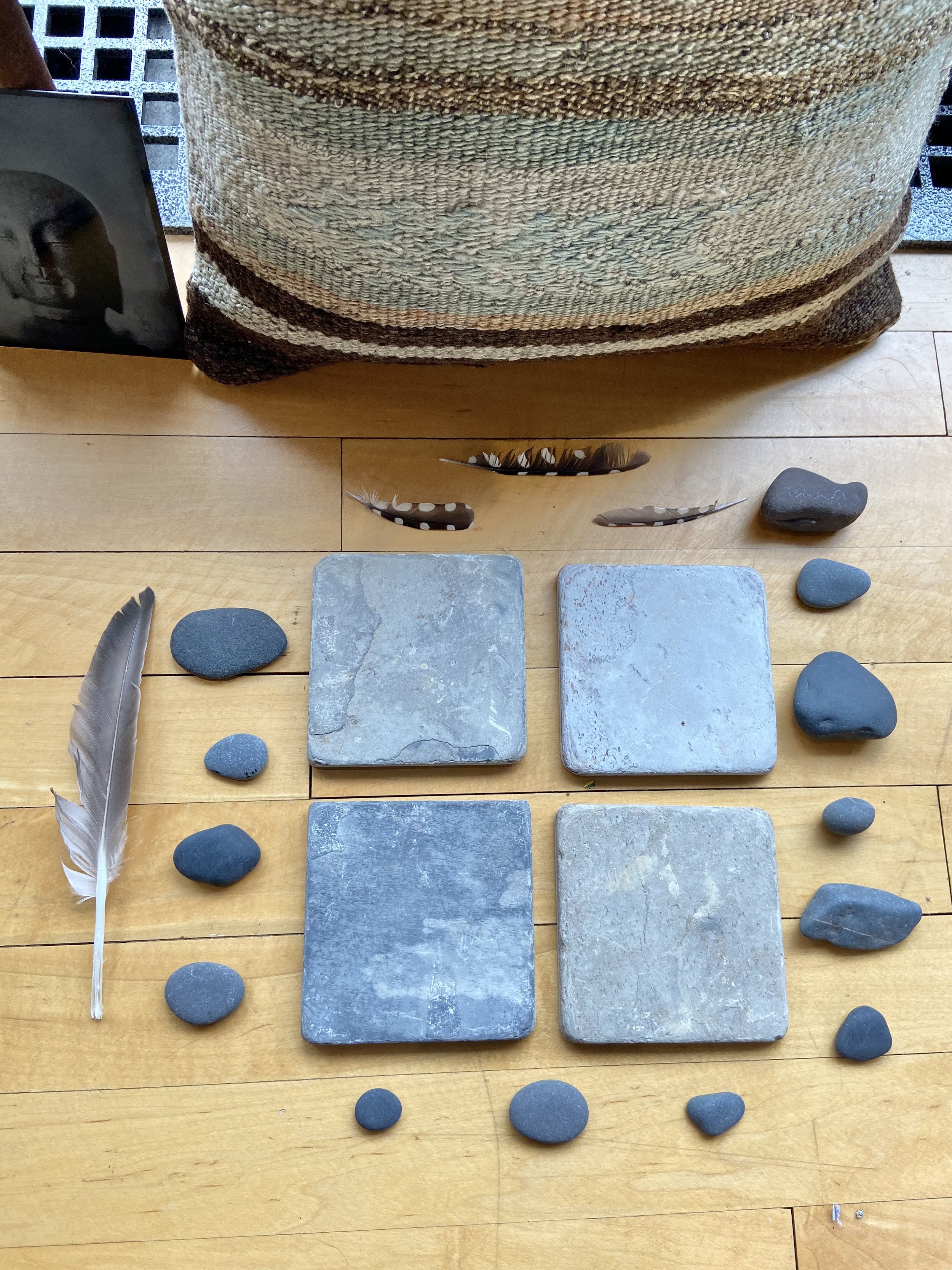 Zen contemplative assemblages of repurposed stone tiles, gathered stones, found feathers, nature connected art, meditative art, contemplative art, peaceful art, mixed media artist in Wisconsin, Emma Freeman Art, textile artist, art as spiritual pract