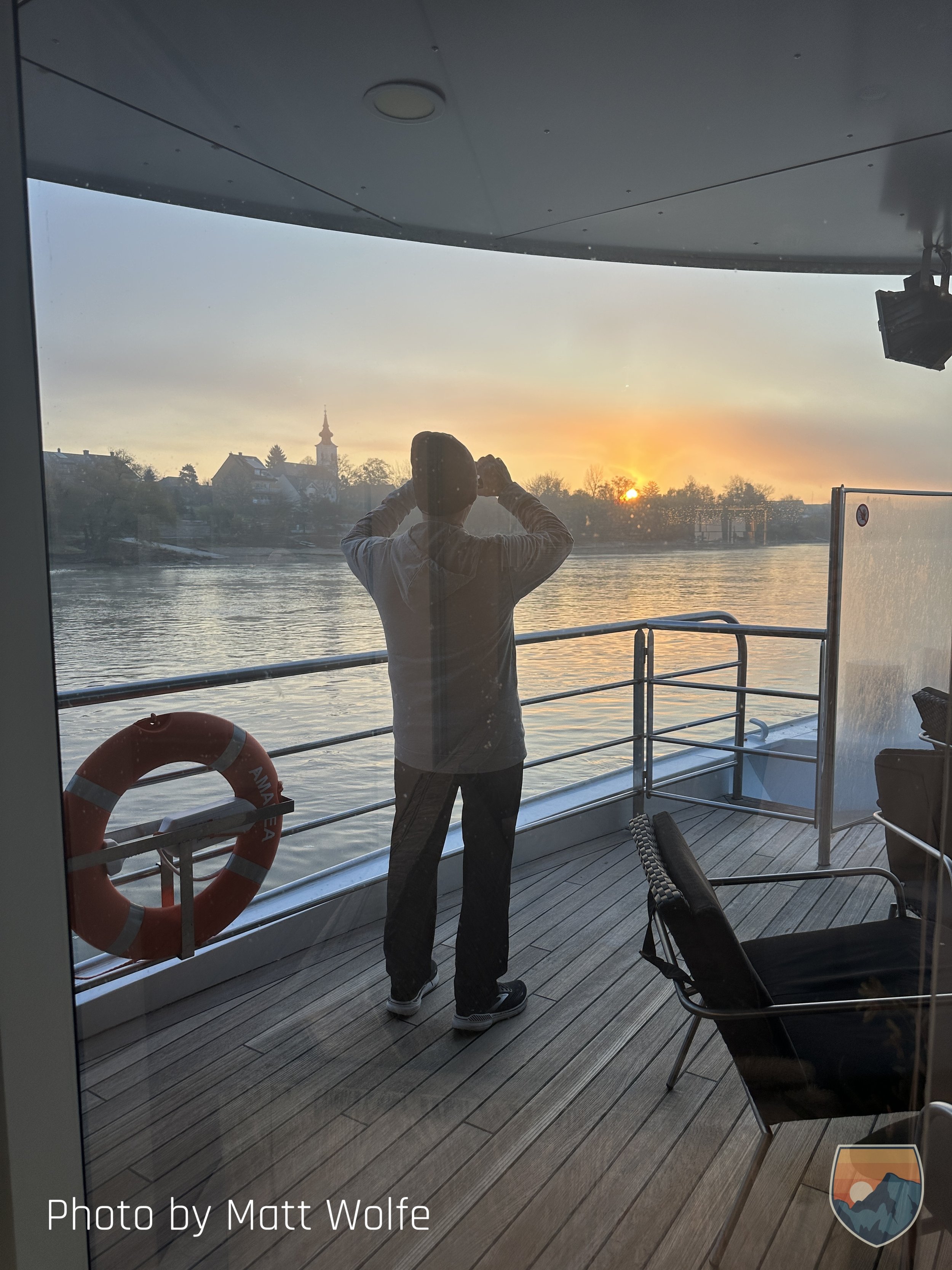 Man standing and watching Sailing into Budapest early morning.