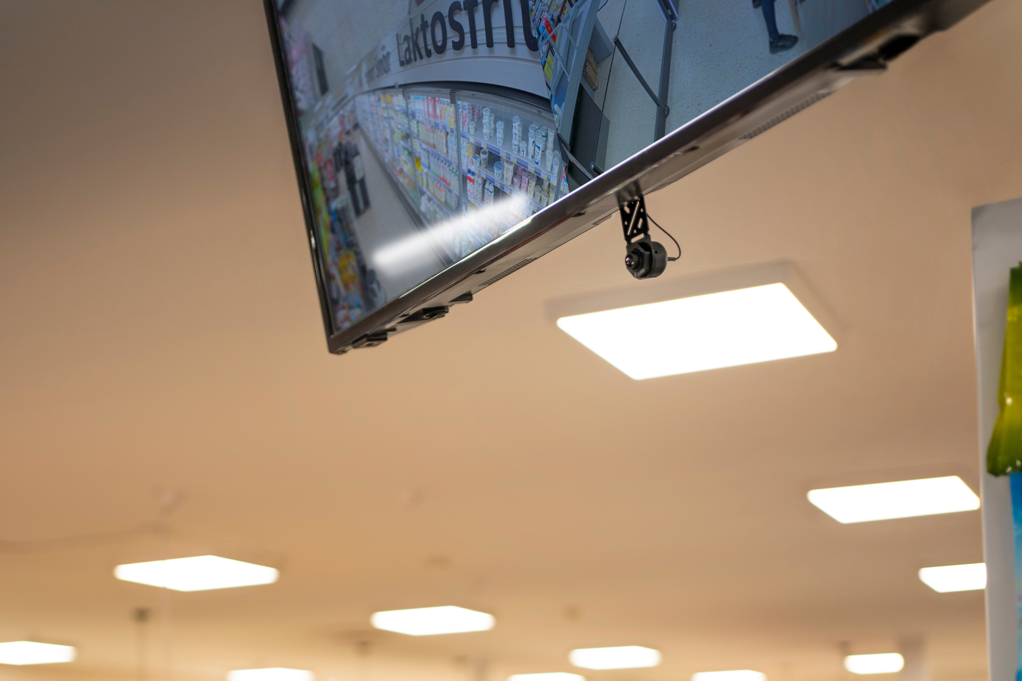 Retail self-checkout system monitored by security camera for loss prevention