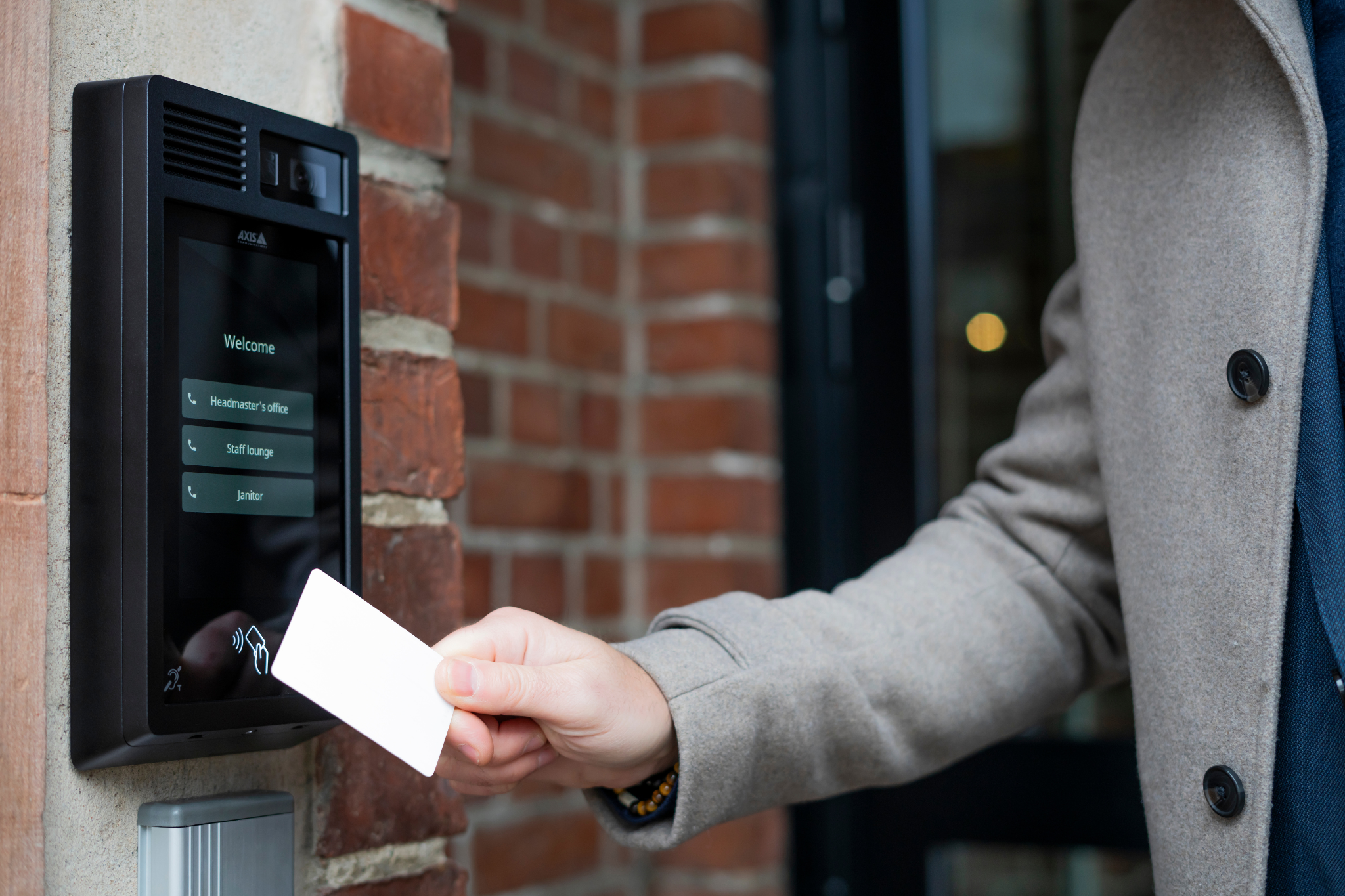 Visitor using intercom system for controlled entry at residential or commercial property