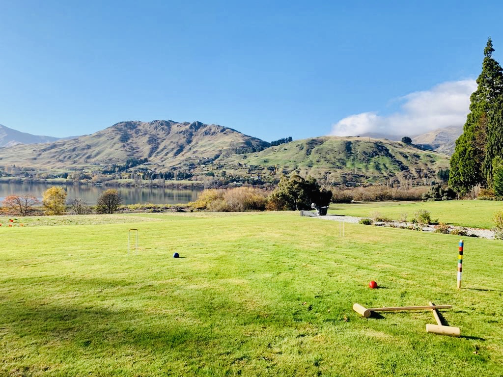 The croquet lawn is in front of the pétanque court with fantastic elevated views over the paddocks leading to Lake Hayes. A croquet set is available to all guests.