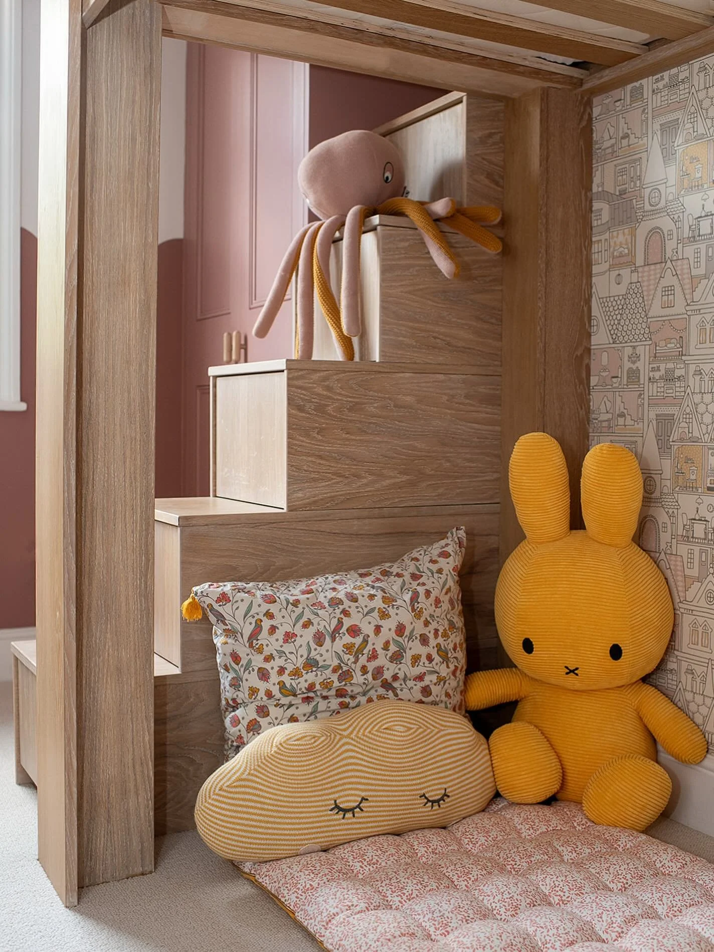 In this Islington kids&rsquo; bedroom, the space under the bespoke joinery bed becomes a cosy nook for play, reading and quiet time. 

It feels tucked away and inviting for the early years, and I designed it with the long term in mind so it can adapt