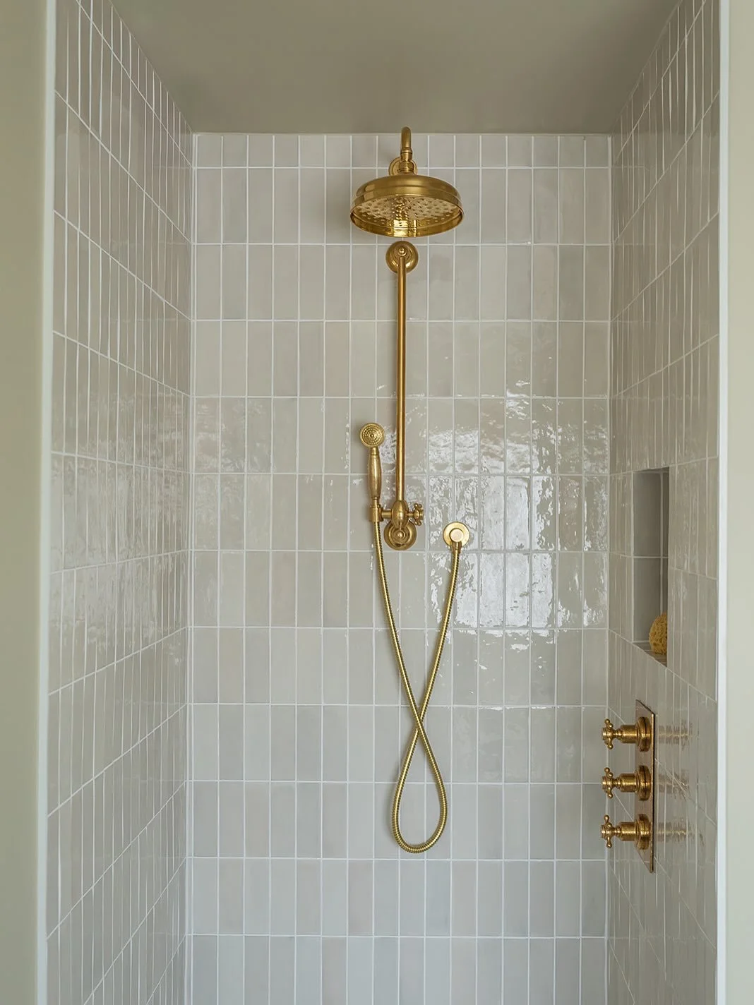 Step into the shower in my Leyton project and you&rsquo;re surrounded by soft, gently glazed tiles that catch the light throughout the day. 

The niche is set neatly into the wall so products don&rsquo;t clutter the space, and the brass brings warmth