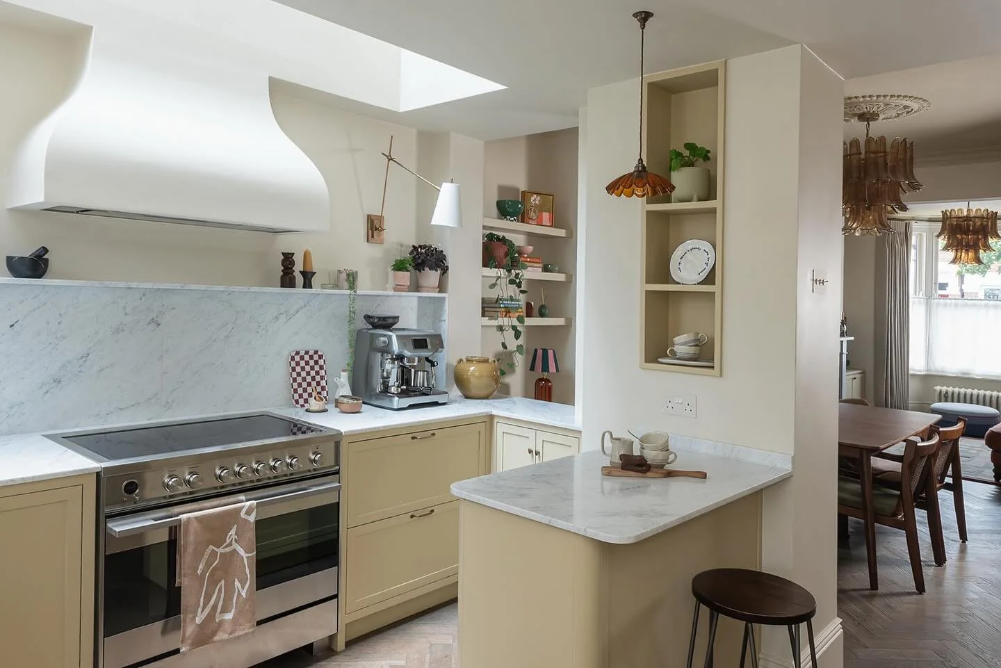 The smallest seat in the kitchen is often the one people use most. If you have the space, adding a small social perch can make a kitchen feel much more connected. 

It does not need to be a large island with lots of stools. As you can see here, a sin