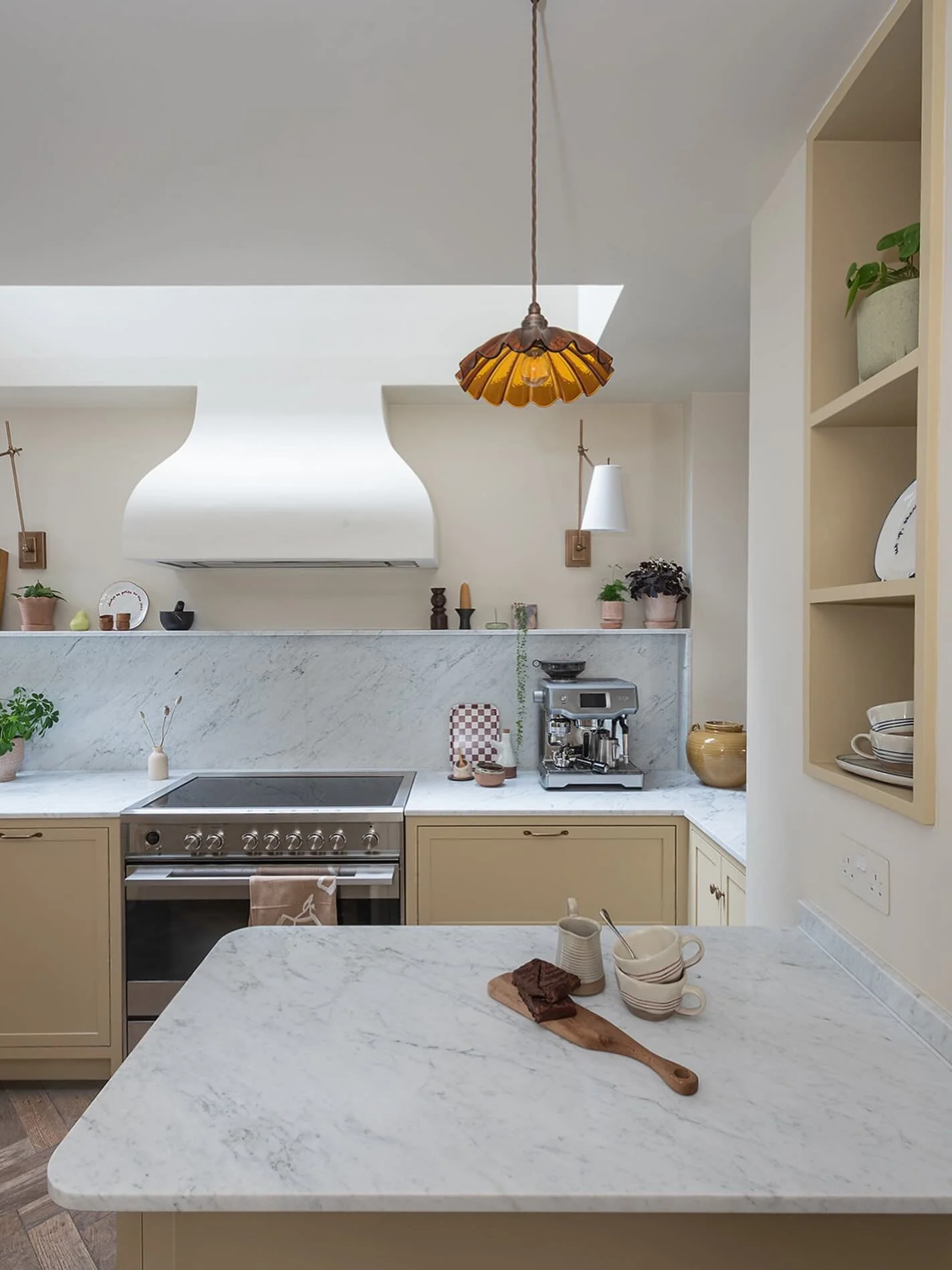 Most cooker hoods are something you try to hide. Here it became the focal point.

Instead of tucking the extractor away, we designed a sculptural plaster hood that brings a softer architectural moment to the kitchen. The gentle curves break up the st