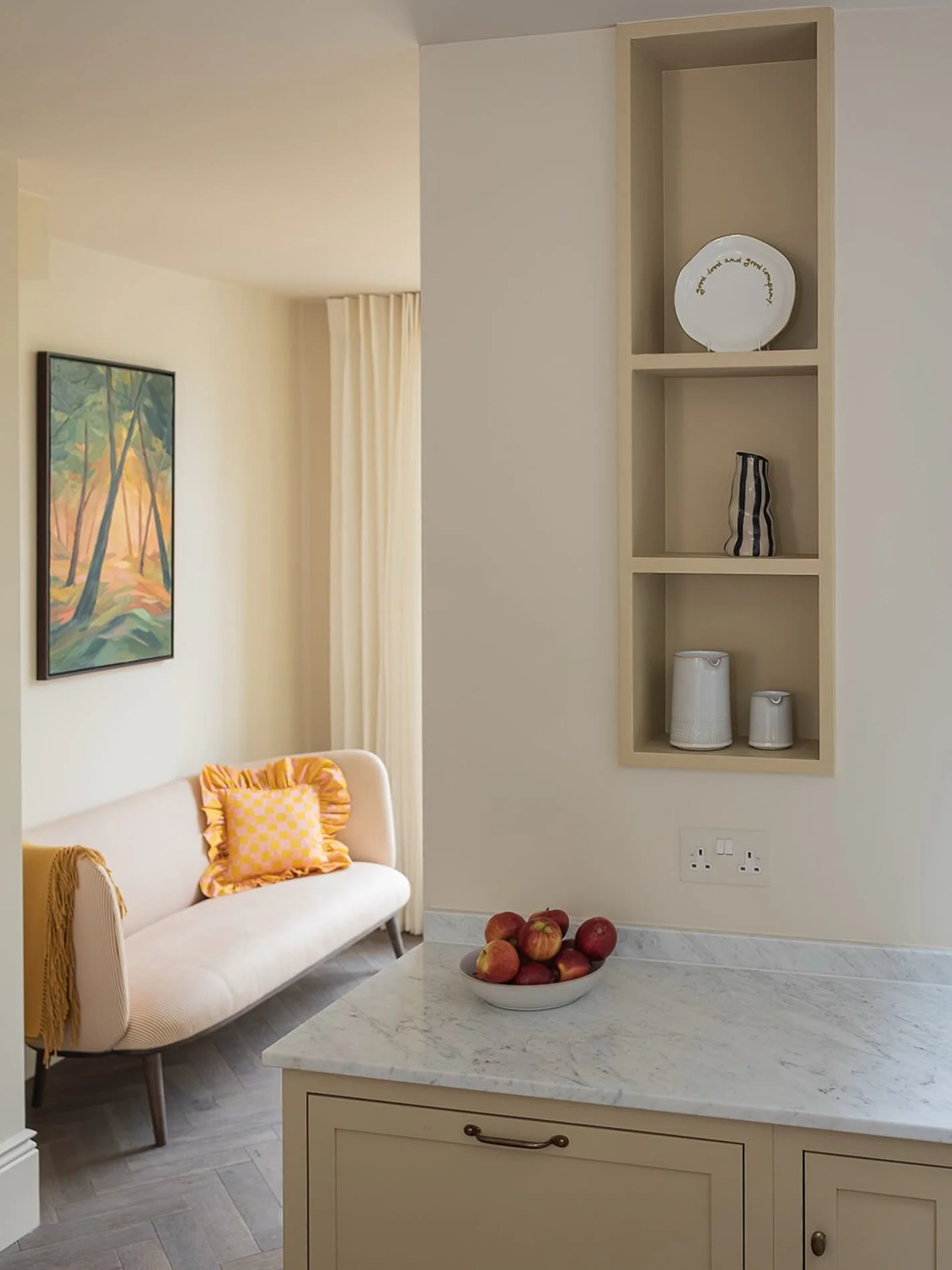 When you are designing a kitchen, it is worth thinking beyond the kitchen itself and how you move through the space.

From here, your eye is drawn straight through to a small seating spot by the garden doors, where natural light fills the room. It gi