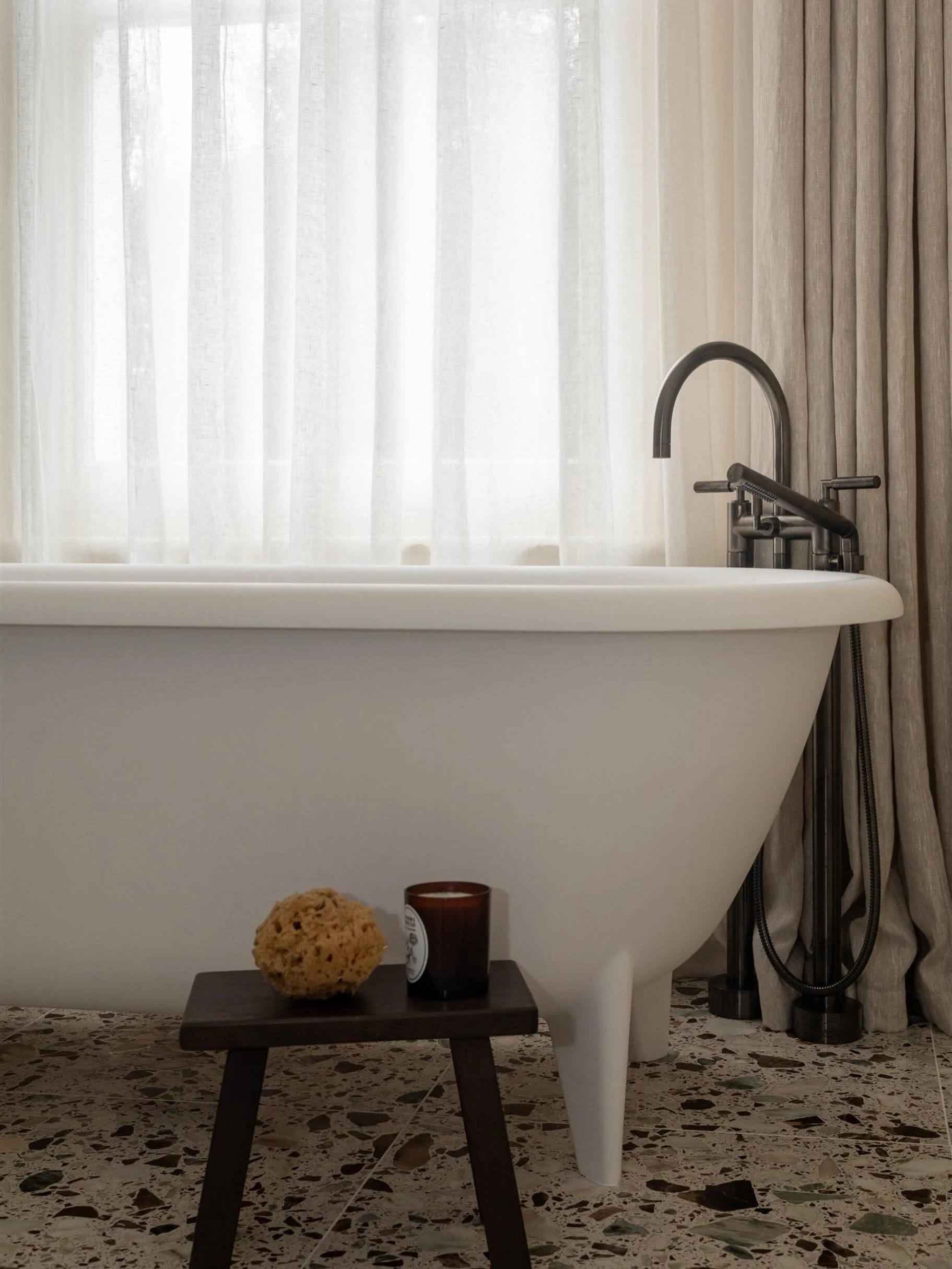 I wanted this bathroom to feel contemporary and clean, but still warm and relaxing. Somewhere that gives you that quiet luxury hotel feeling, while still working perfectly for everyday life.

The soft linen curtains, terrazzo flooring and dark bronze