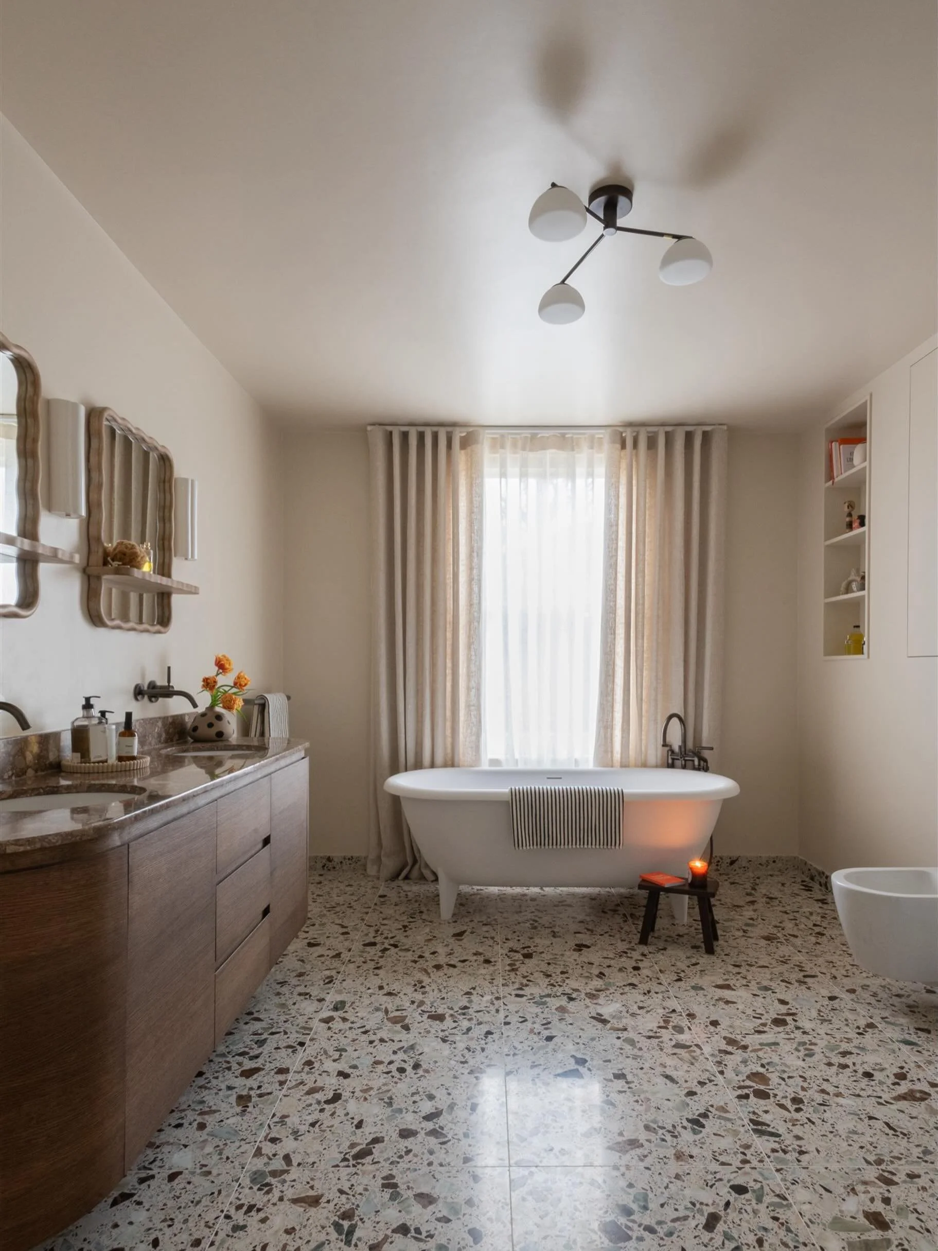 This bathroom is generous in scale, but I really wanted it to still feel cosy and welcoming despite its size.

A big part of the design was about introducing softness and layering through texture, lighting and materials. The terrazzo floor helps grou