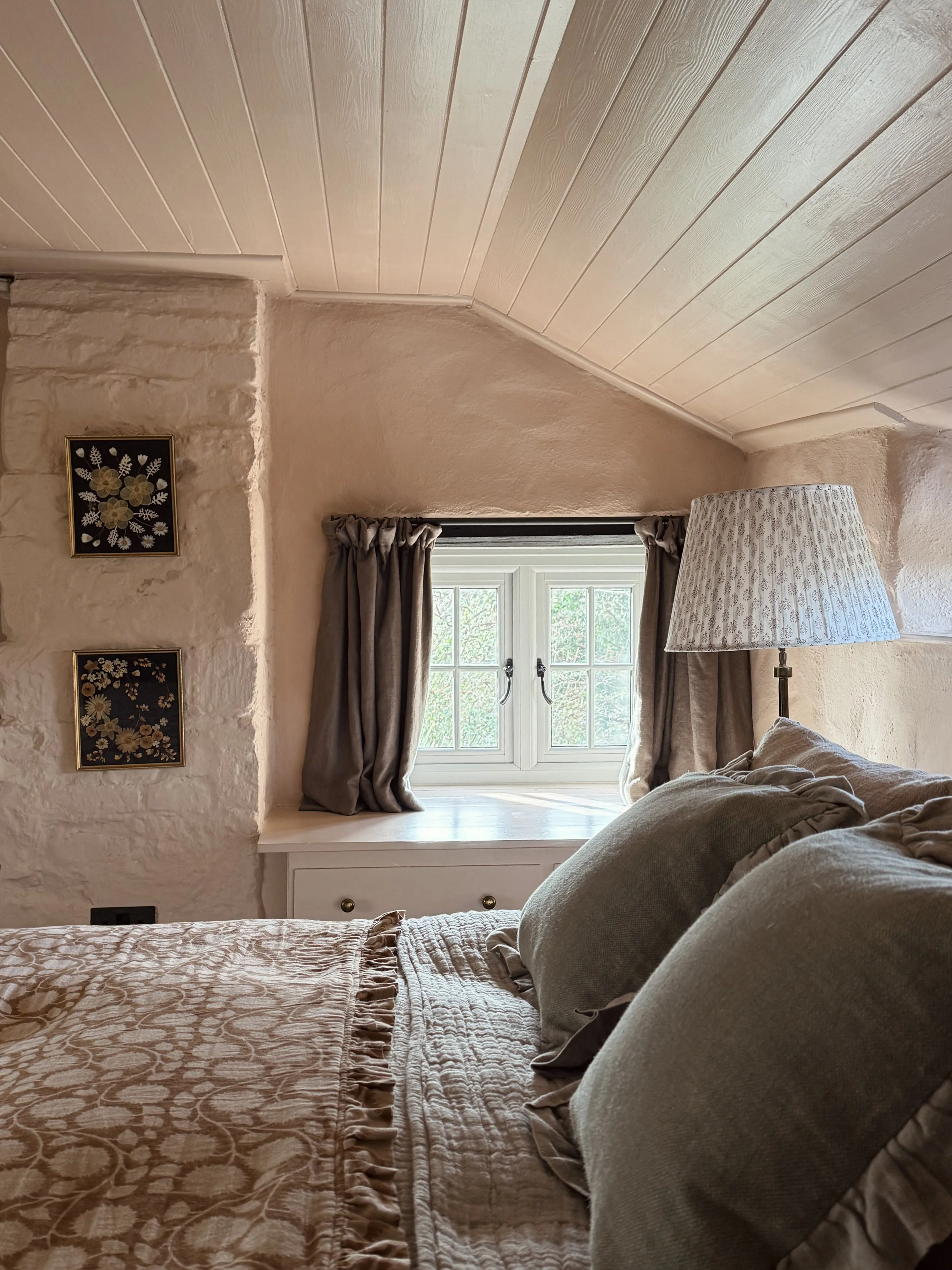 Beautiful romantic bedroom for two adults at luxury holiday cottage The Dorset Nook. With fine linens and antique furniture, stylish and cosy interiors. 