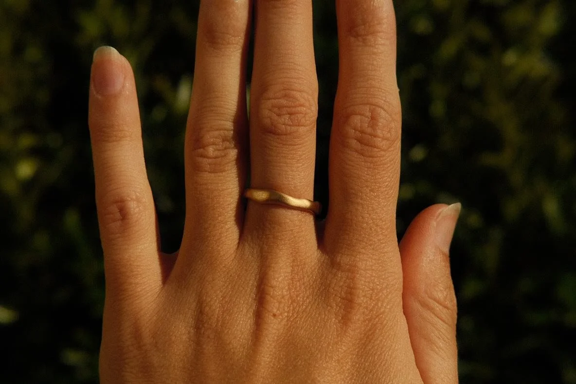 A wedding ring like no other, hand-carved from jewellers wax, in an ancient tradition passed down for centuries. 

Cast using the lost wax technique into buttery 18k recycled yellow gold, forged to add more strength, then finished with a satin sheen.