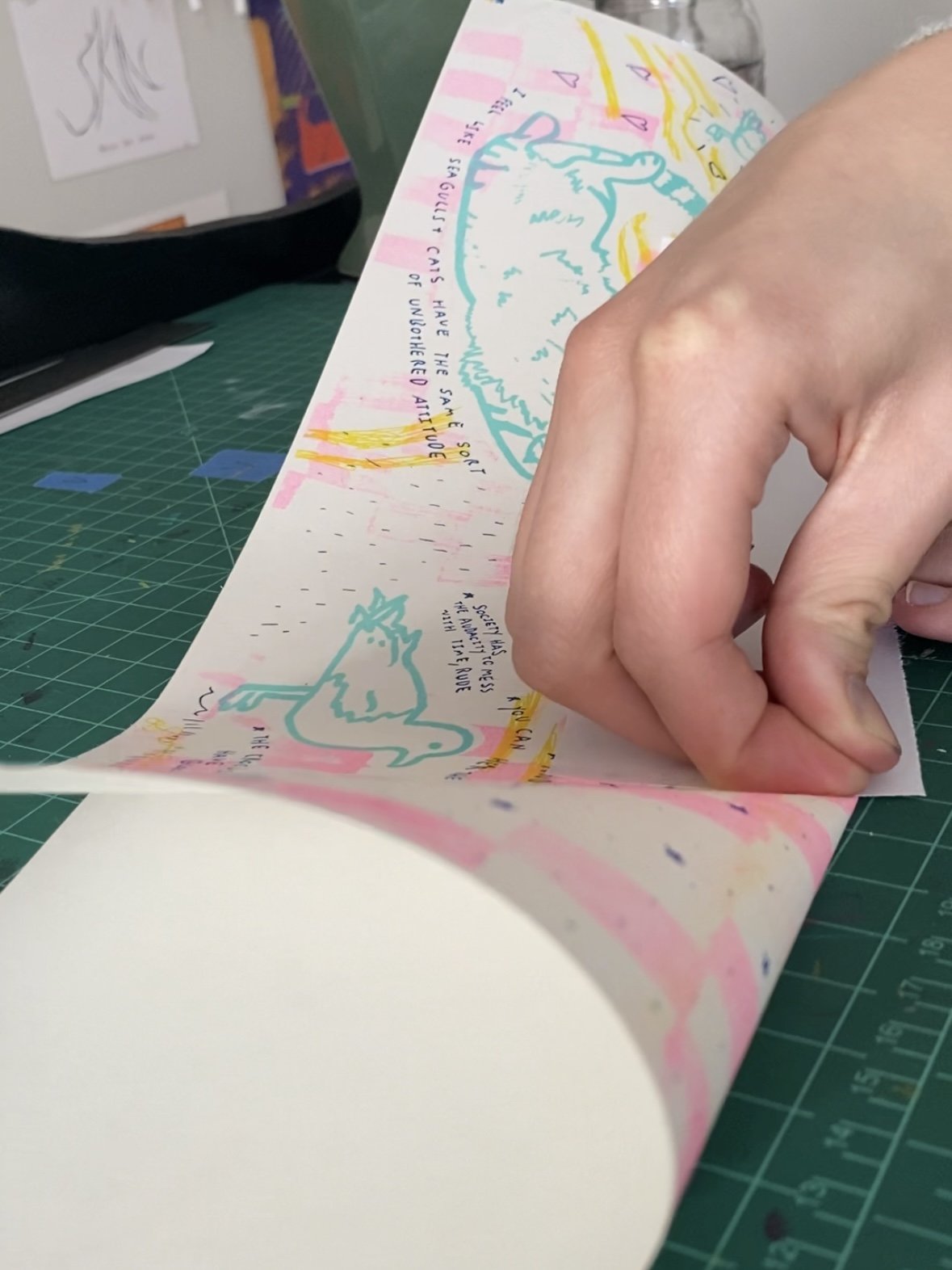 Once my prints were done and had dried for a week I began folding them. I put a clean piece of paper between the print and my hand so not to smear it. Riso Ink never 100% dries so you must be careful handling the prints or it will rub off like charco
