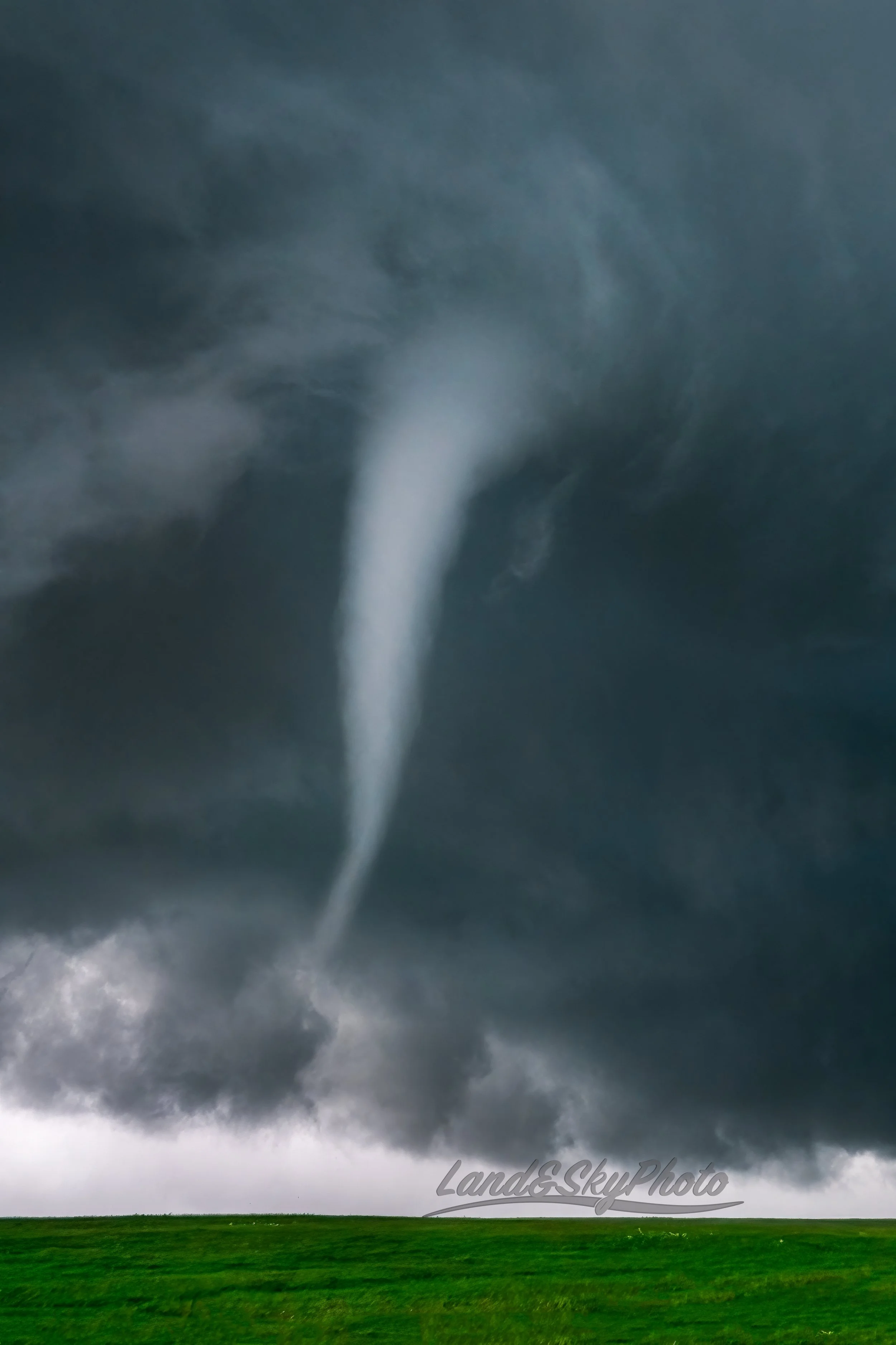 A gorgeous white funnel dances close range in some Wyoming fields intermittently touching down.