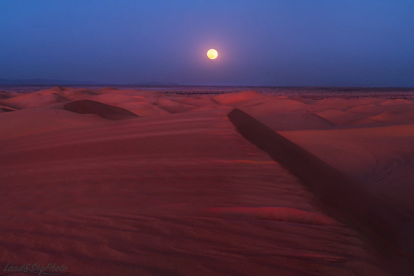 Red Post-Dusk light caused by forest fires bathes the Imperial Sand dunes in an other worldly glow.