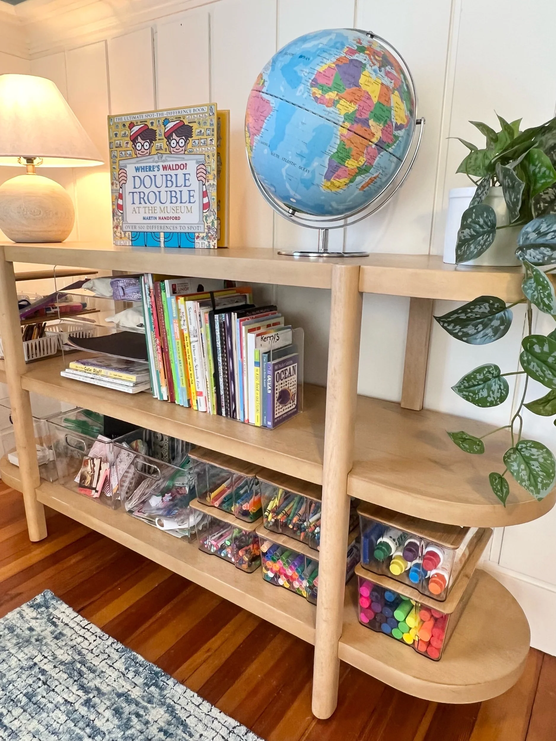 Playroom shelving for books and arts and crafts with globe on top