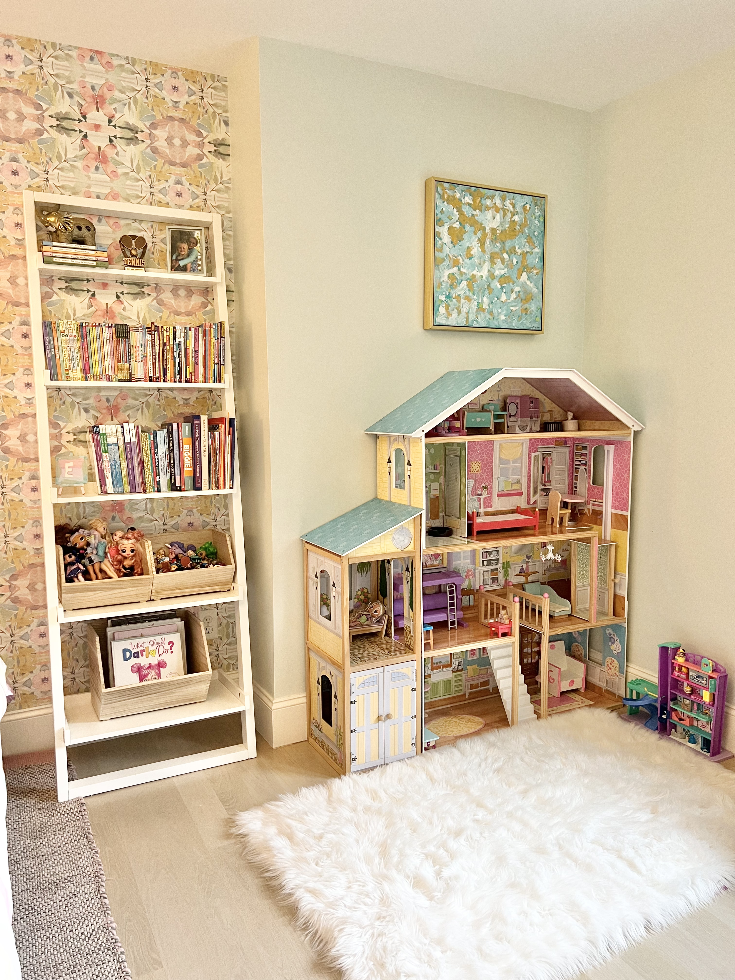 Child's dollhouse setup with cozy rug in bedroom