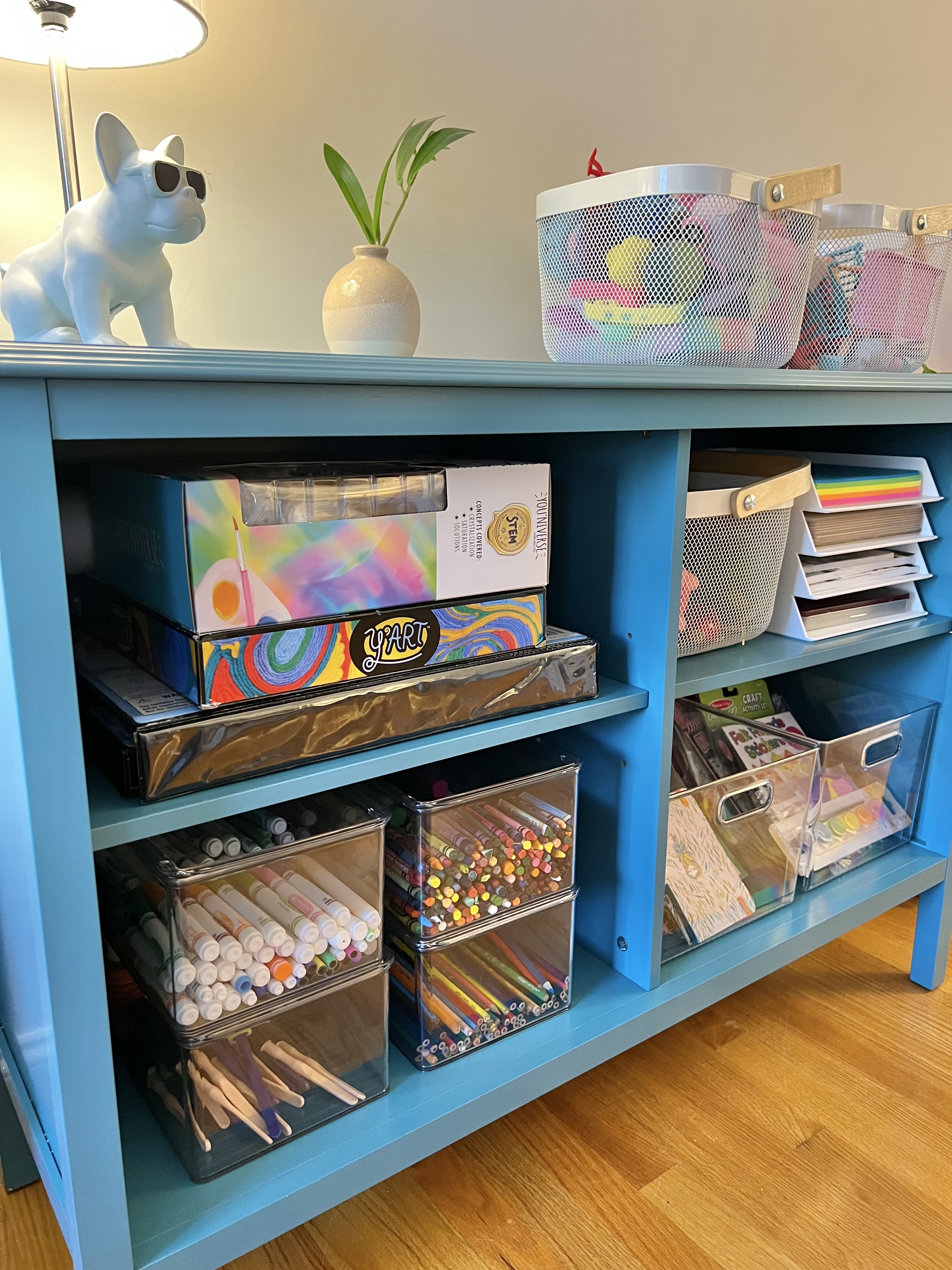 Arts and crafts storage for child's playroom with dog lamp