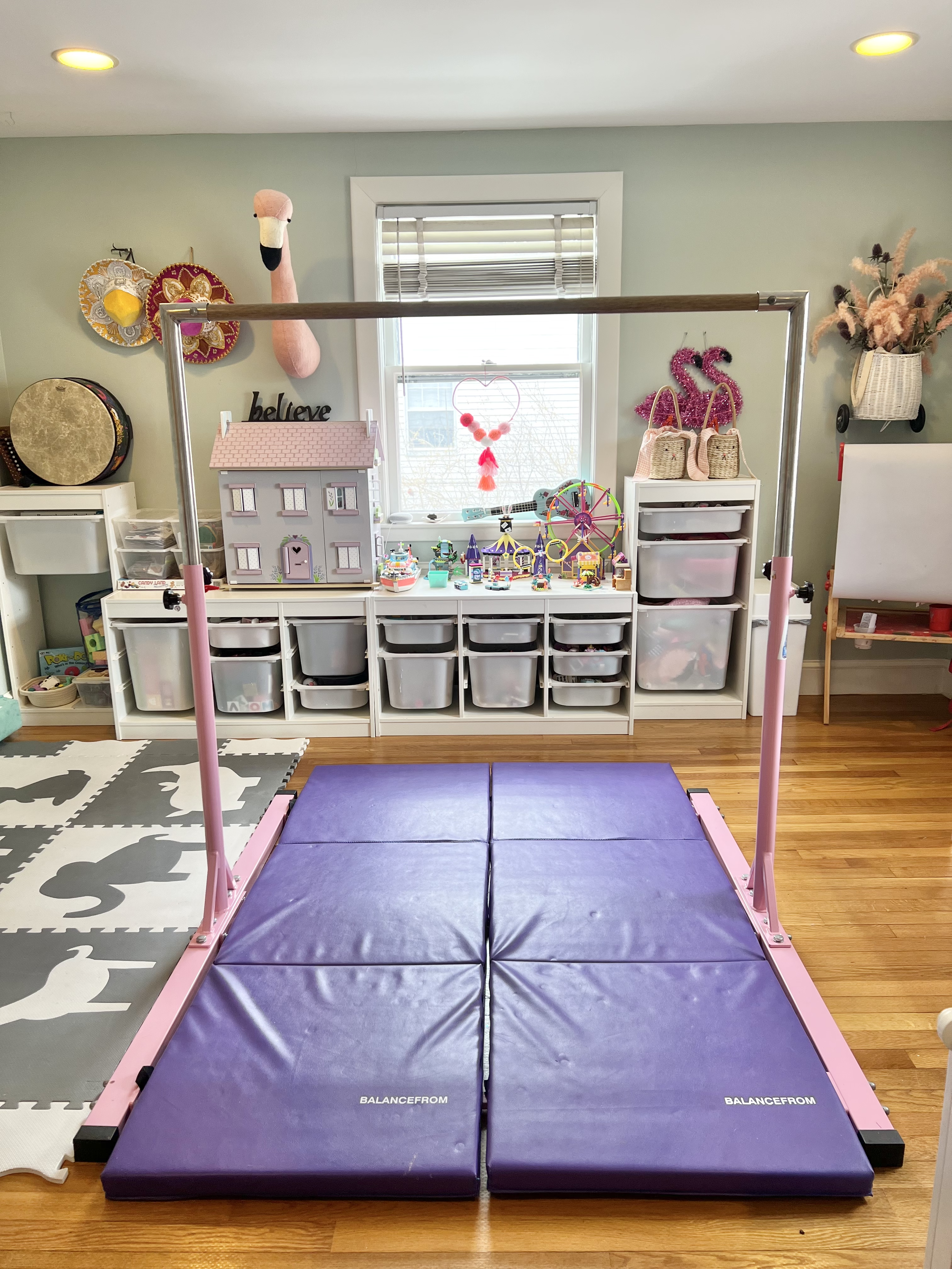 Kid's gymnastics bar in playroom with IKEA toy storage in background