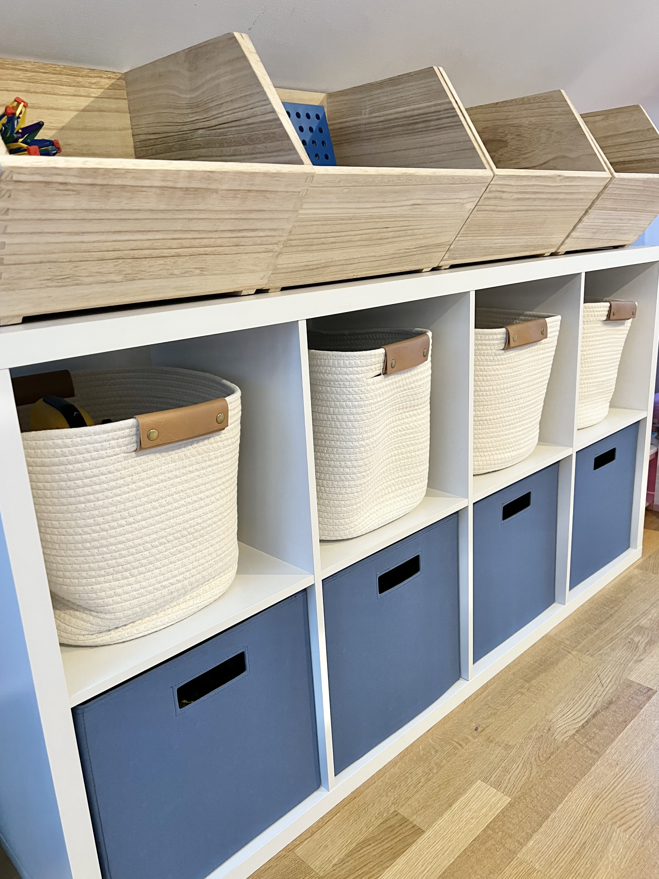 Child's playroom toy storage bins and shelves