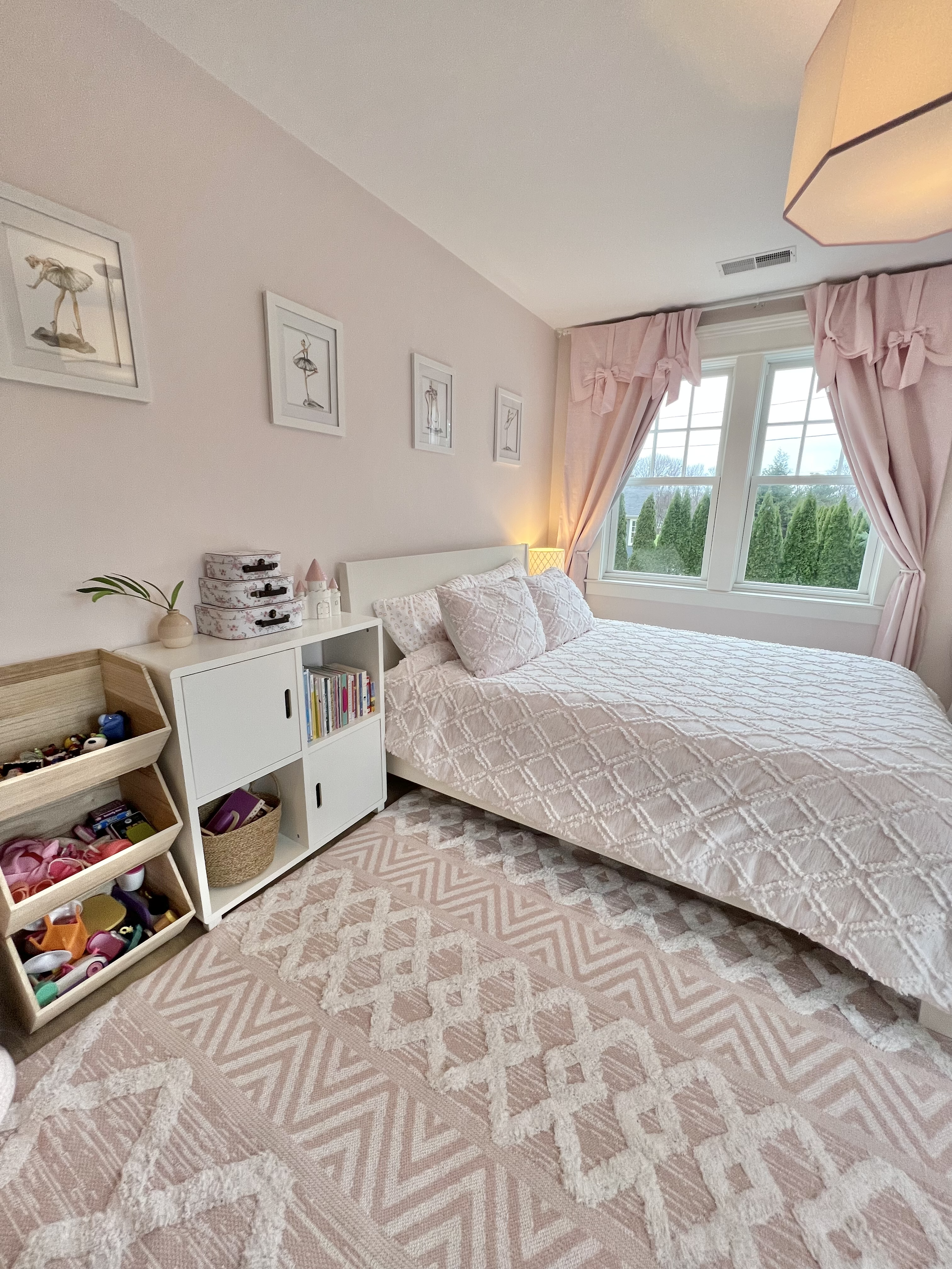 Child's bedroom in all pink with stackable toy storage