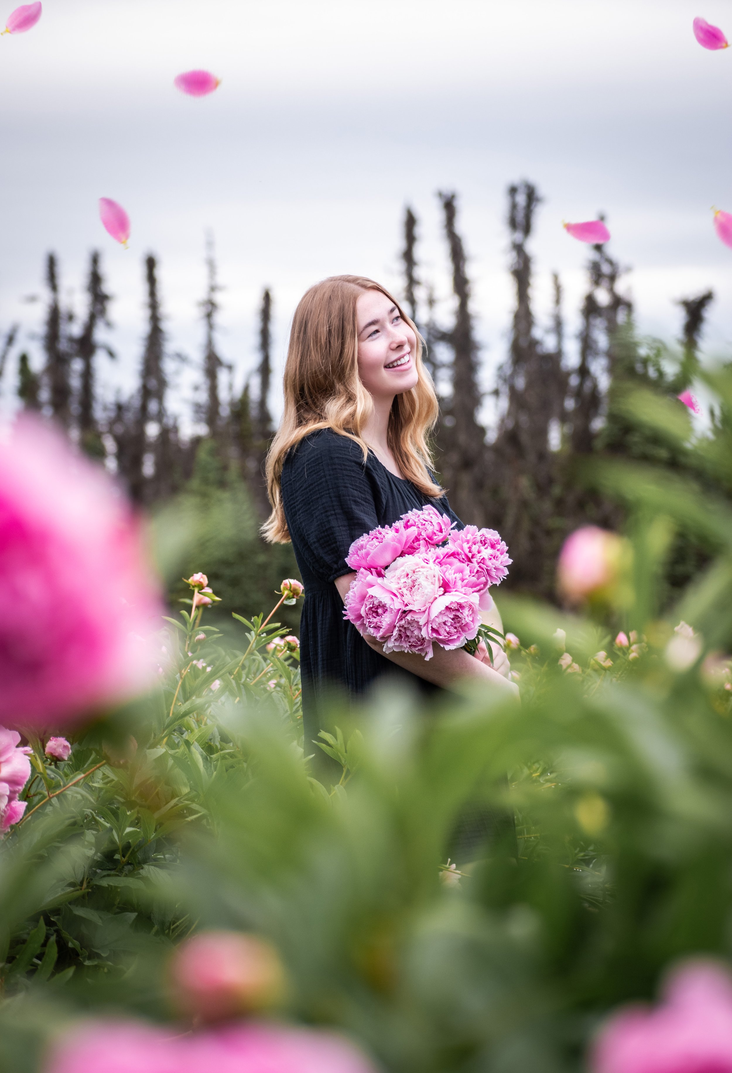 Woman in white dress standing in field of purple flowers