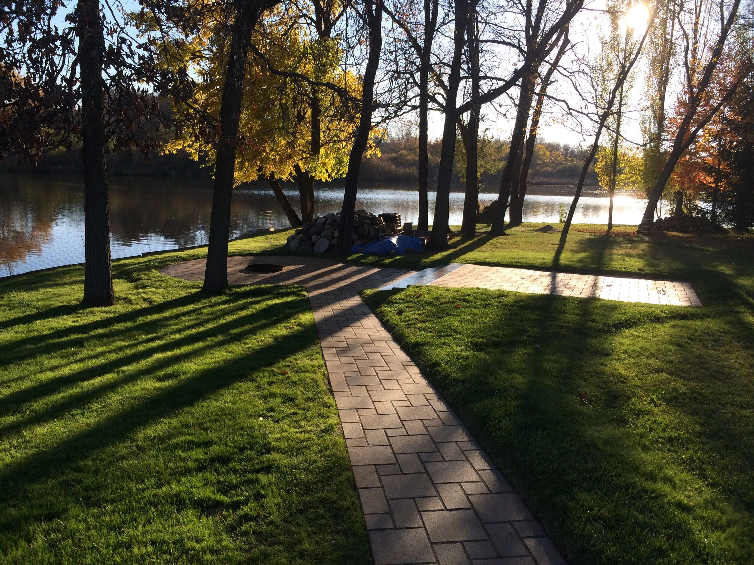 Brick paver path and fire pit for a perfect night by the lake.