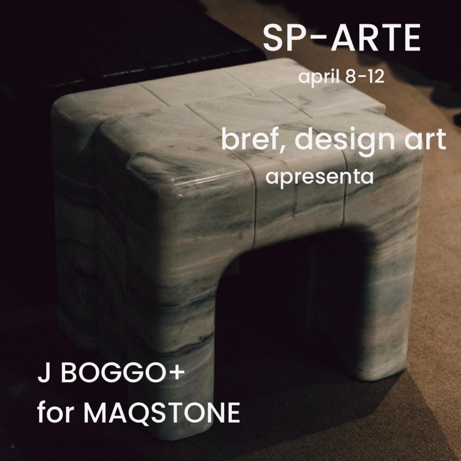 A marble side table with curved edges and hollow space underneath, with overlaid text about an art exhibition.