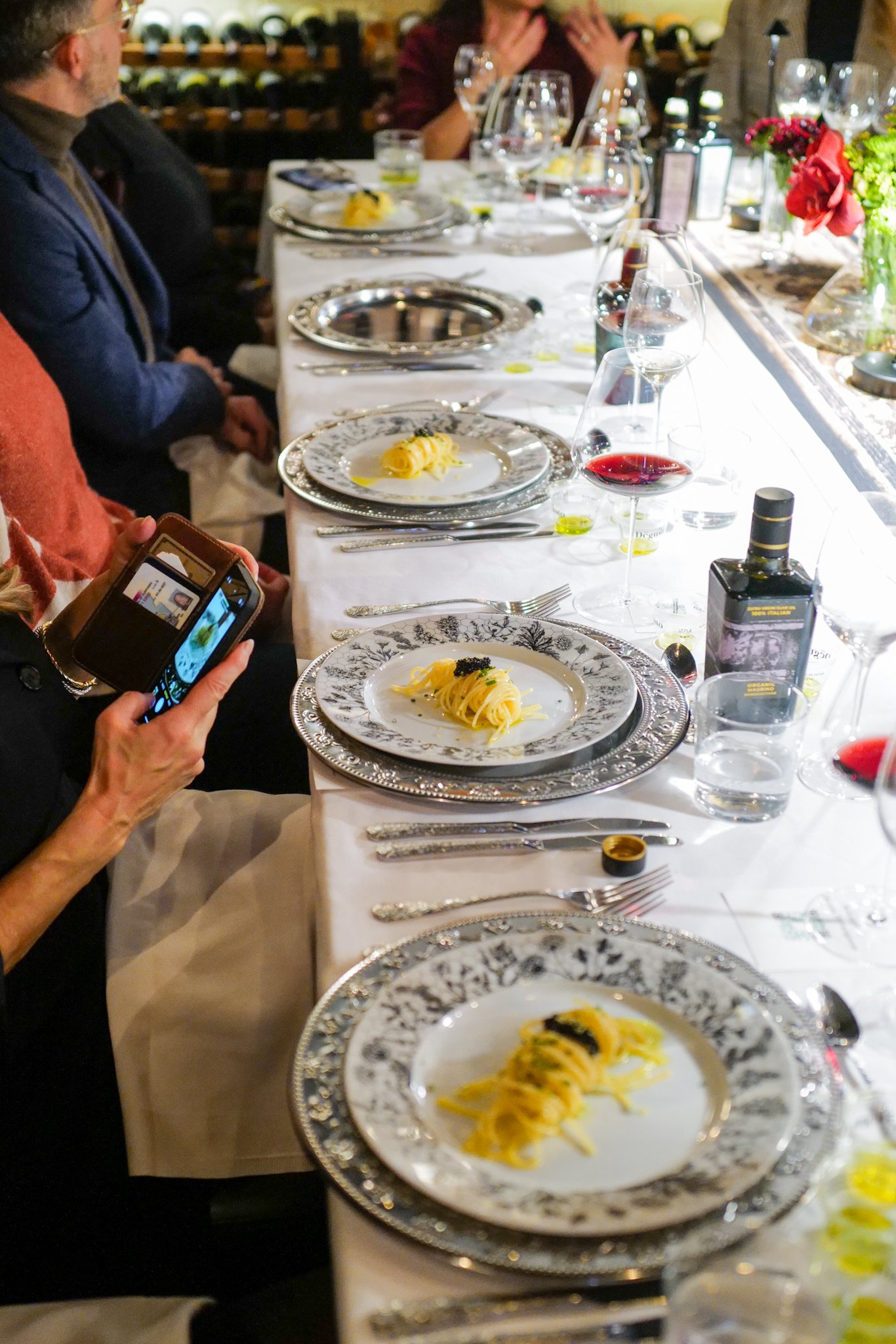 Italian fine dining table with pasta and wine at Lucciola NYC