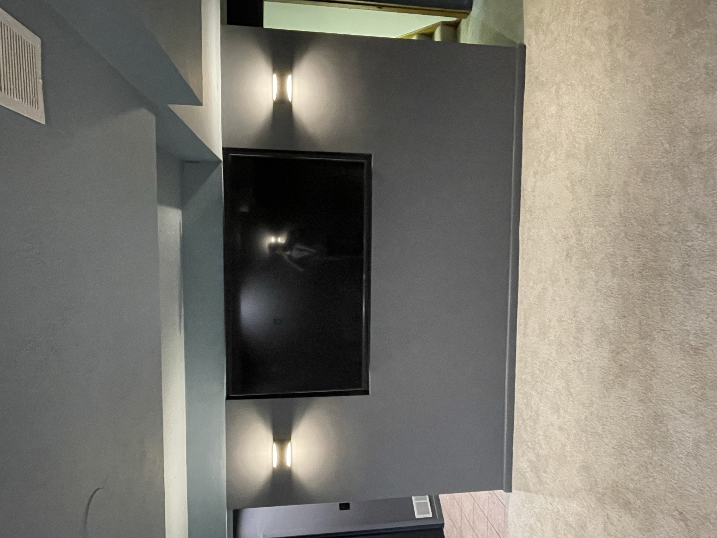 AFTER: CUSTOM-BUILT WALL WITH RECESS FOR TV