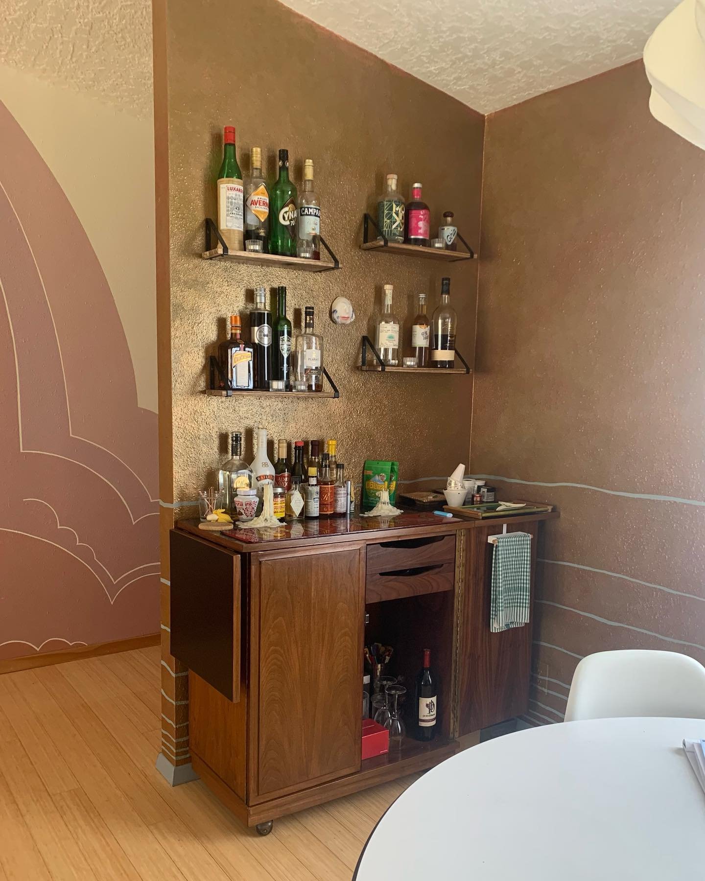 Just a few of my favorite dining room &ldquo;homements&rdquo;. This gold wall is a 3 layer wash, with organic blue lines to evoke the water element; according to compass school Feng Shui. The plan is to replace the sheer white drapery with Emerald gr