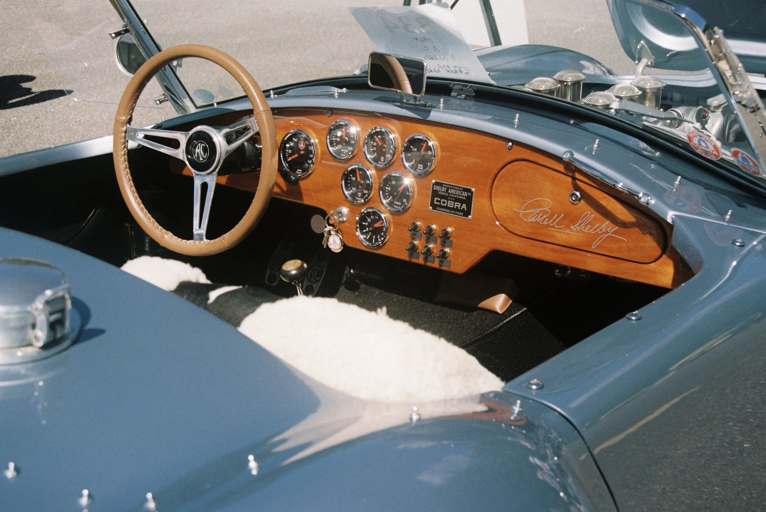 An image of the interior of a classic car featuring a signature on the dashboard.