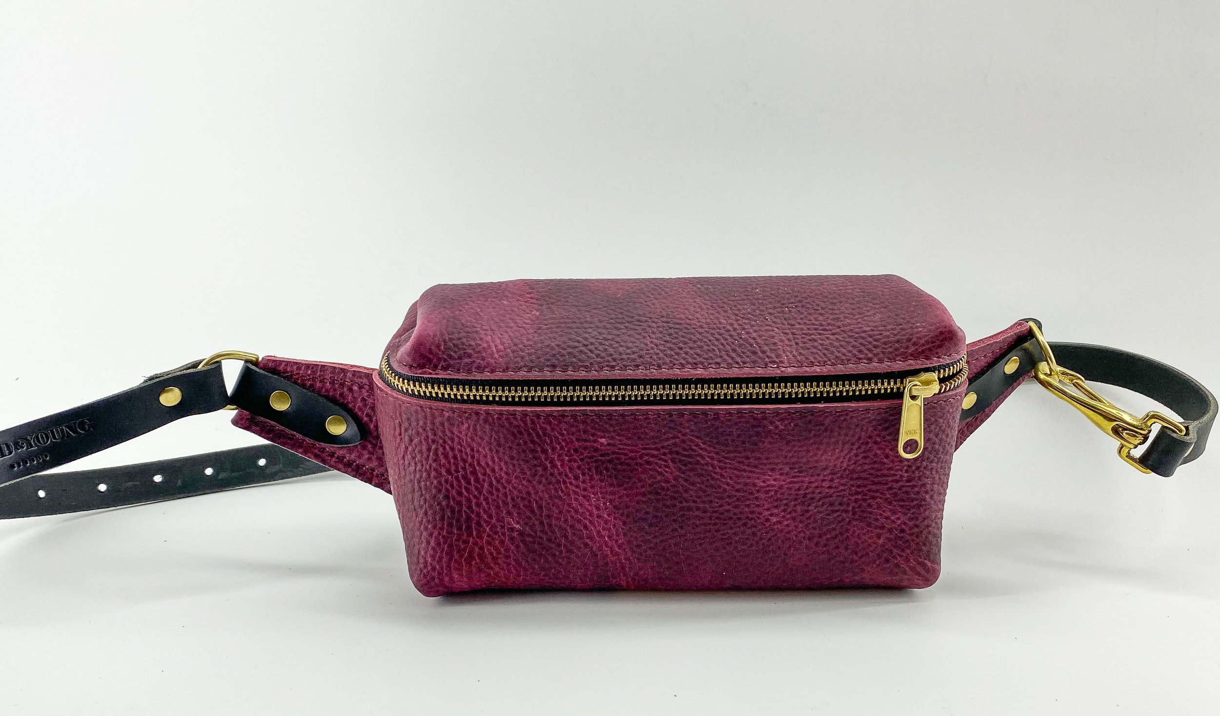 A burgundy leather crossbody bag.