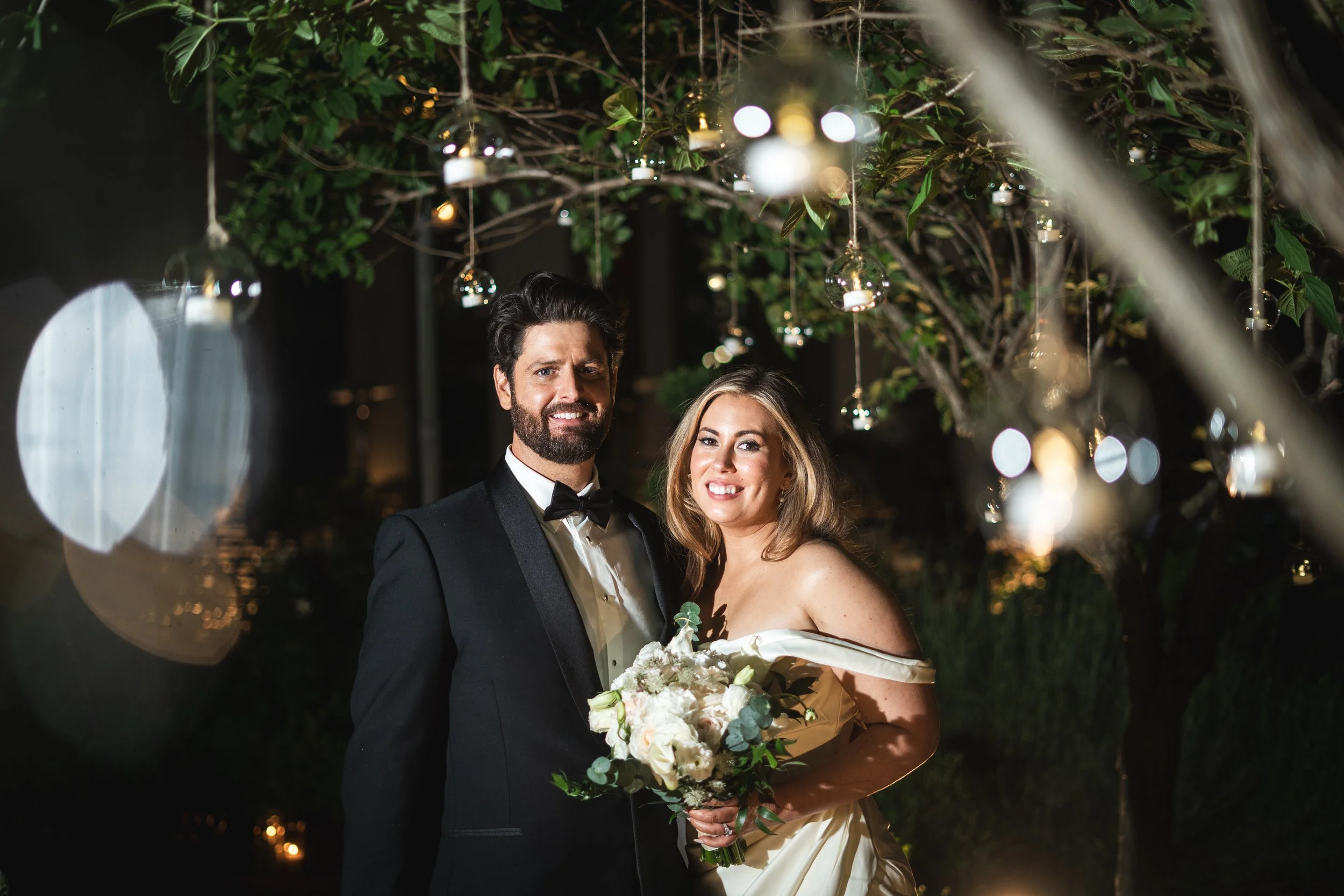 the bride and groom in sparkling lights at night