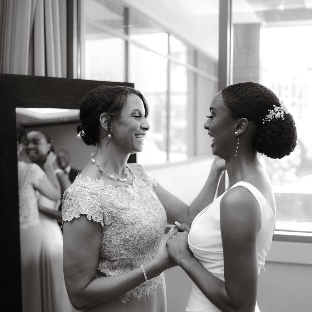 Bride laughing with her mother on her wedding day
