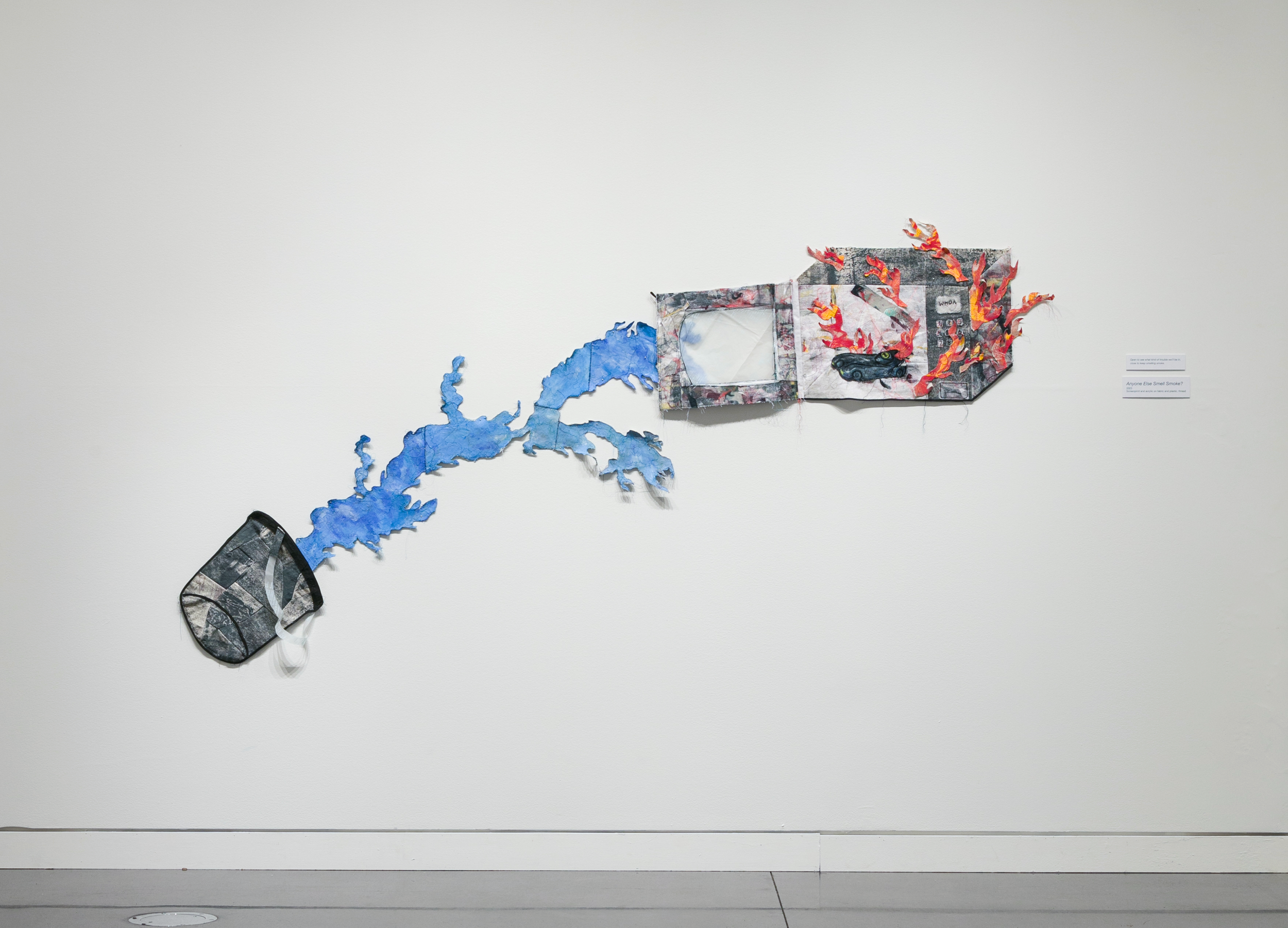 Anyone Else Smell Smoke?; screenprint and acrylic on fabric and plastic, thread; 2023