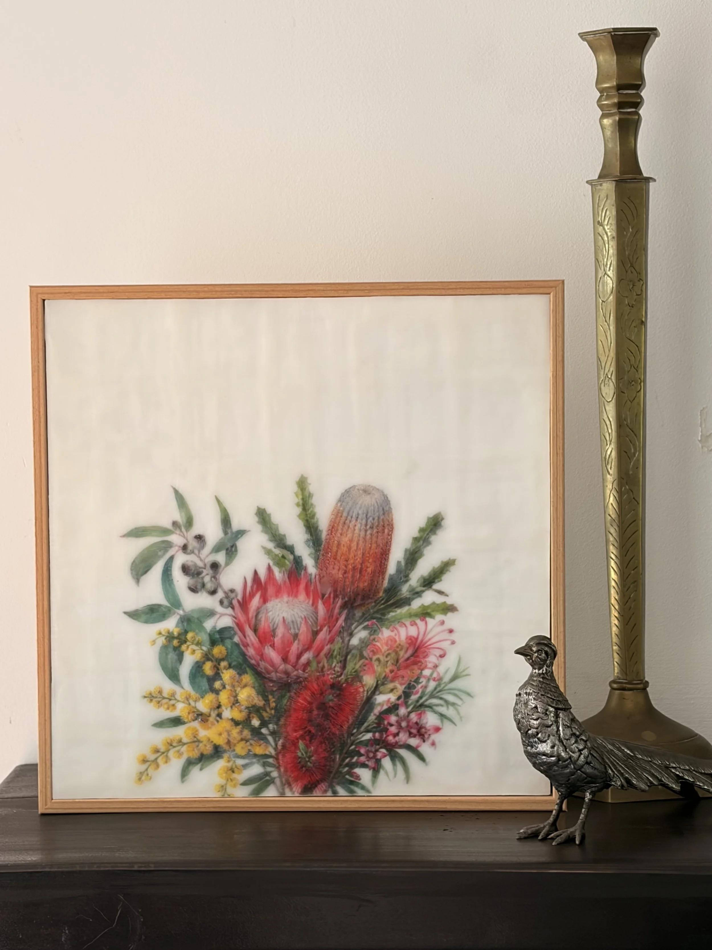 Encaustic wax and mixed media artwork featuring Australian native flowers including banksia, protea, bottlebrush and wattle on a soft ivory background, framed in natural timber.