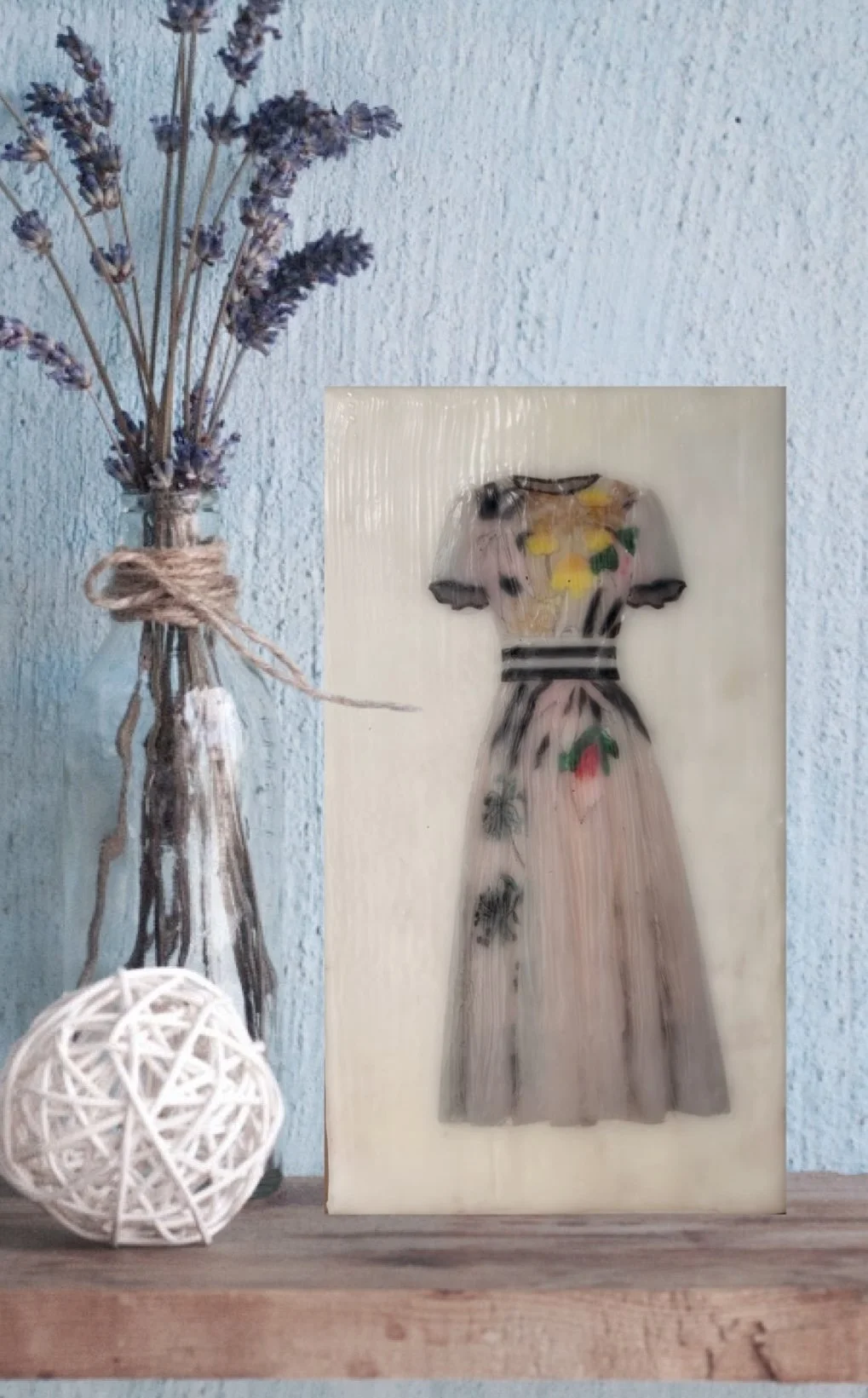 Encaustic wax mixed media artwork of a soft floral dress in blush tones on a sculptural block