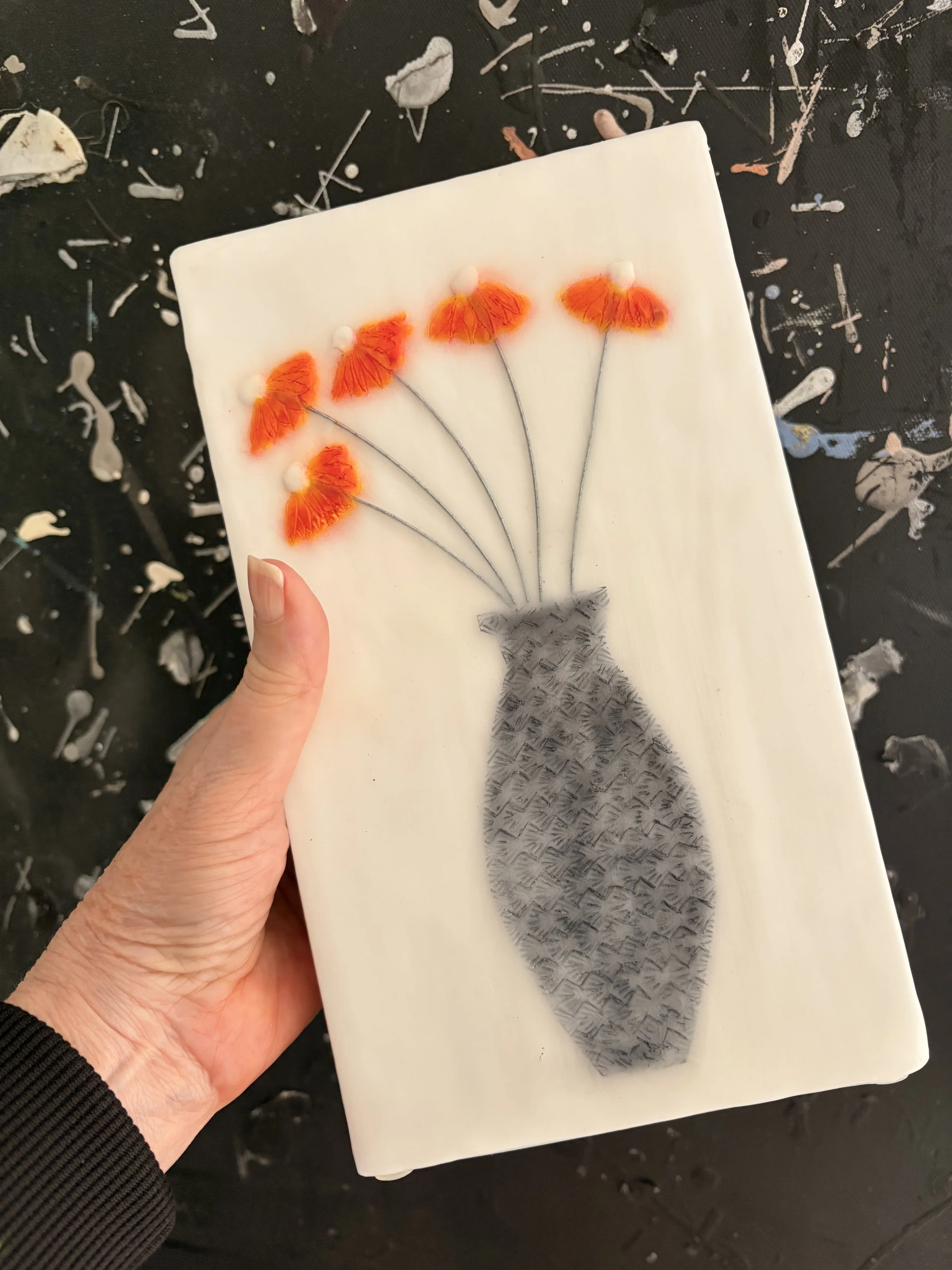 Encaustic wax and mixed media block artworks featuring stylised vases with delicate pink and orange flowers on textured white backgrounds, arranged as a cohesive decorative series.