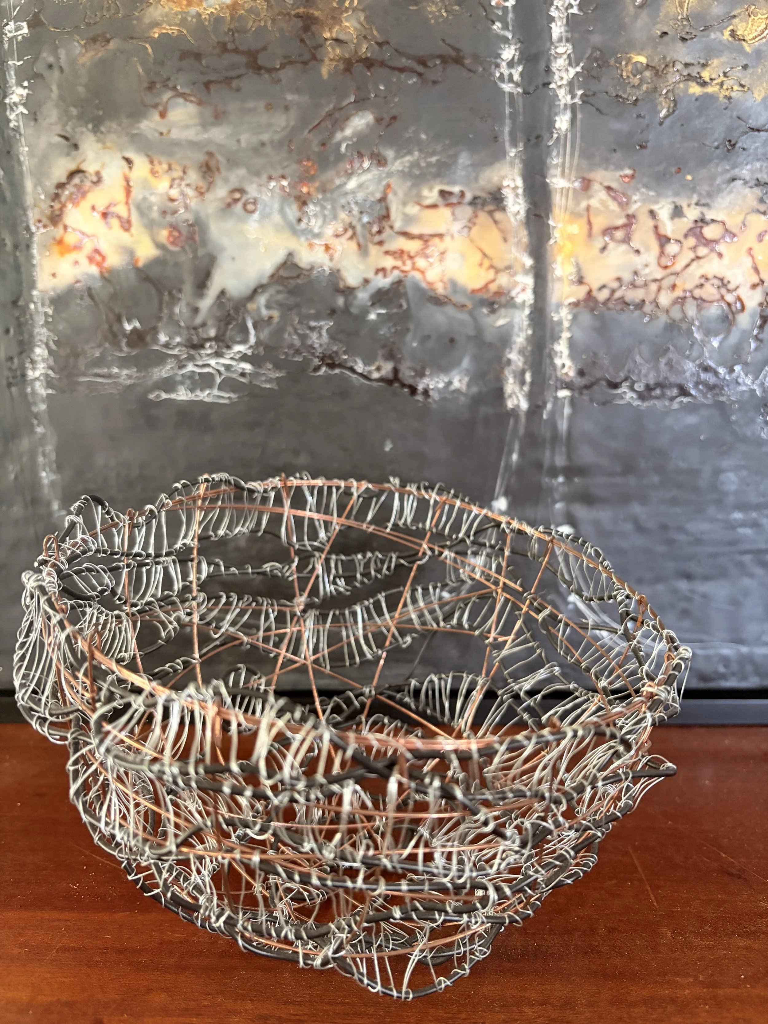 Handcrafted wire sculpture bowl made from copper and steel wire, featuring an organic woven design with layered textures, displayed as a contemporary sculptural vessel.