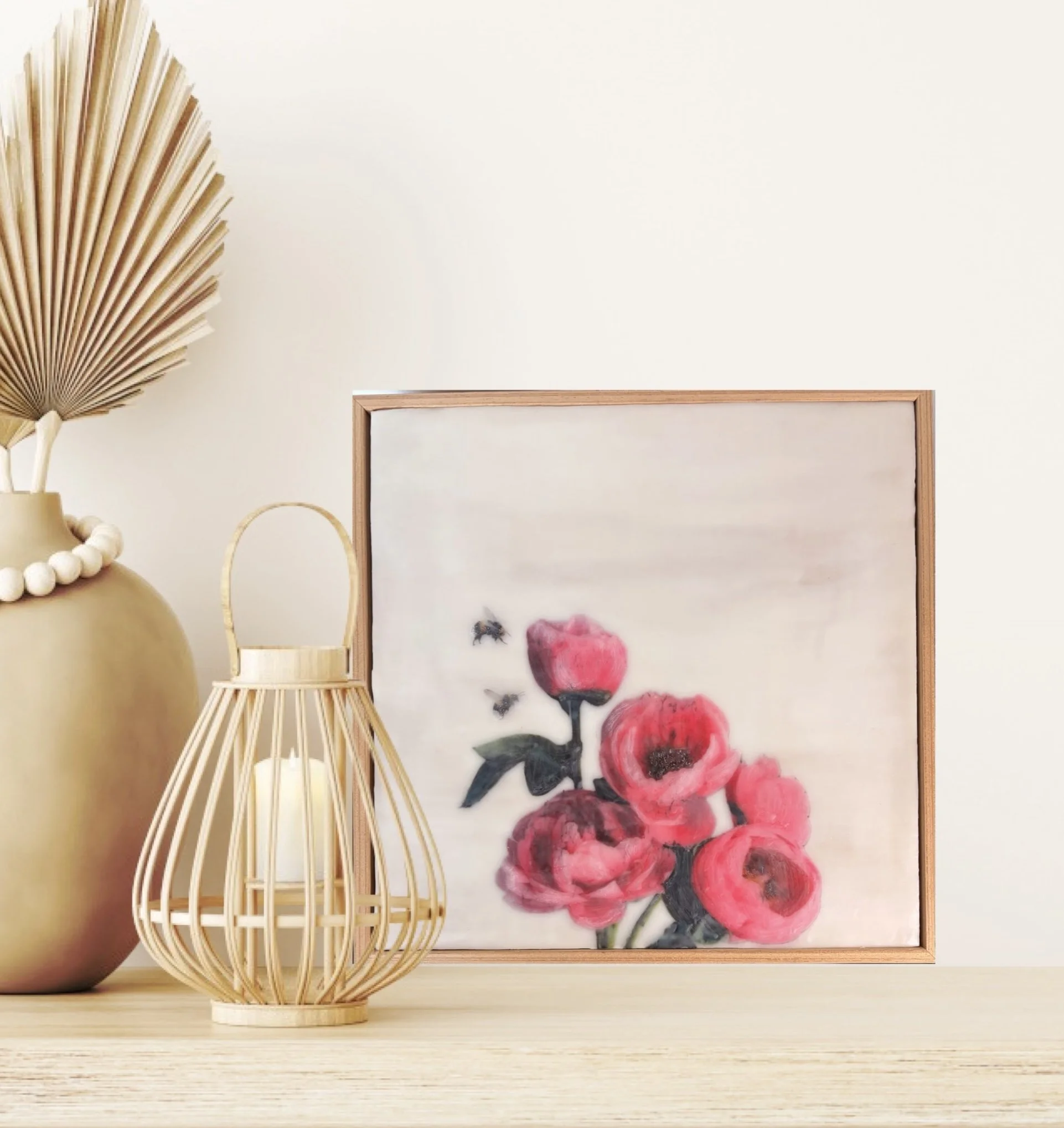 an encaustic wax/mixed media artwork of soft pink flowers and two bees