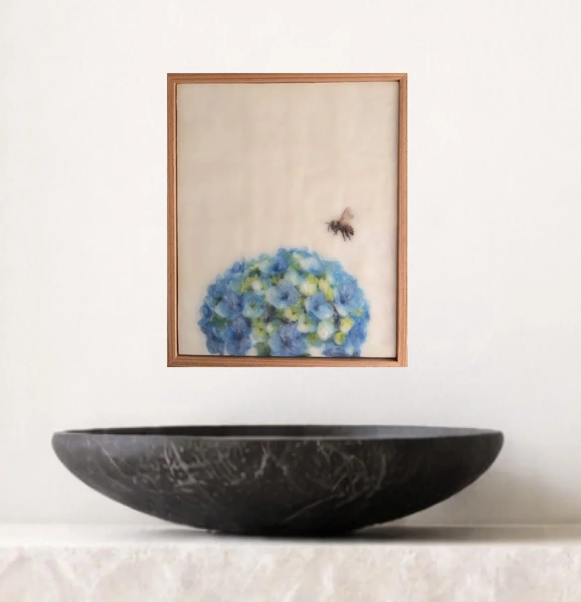 Original encaustic wax artwork featuring a honeybee hovering above blue hydrangea flowers, framed in Tasmanian oak with soft translucent beeswax layers.