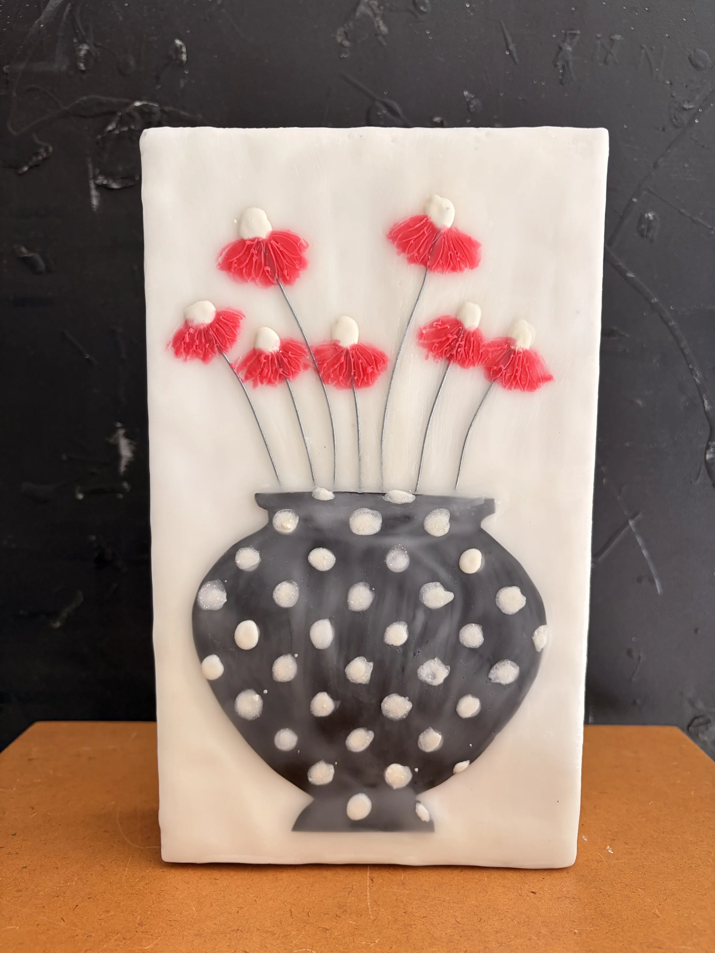 Encaustic wax and mixed media block artworks featuring stylised vases with delicate pink and orange flowers on textured white backgrounds, arranged as a cohesive decorative series.