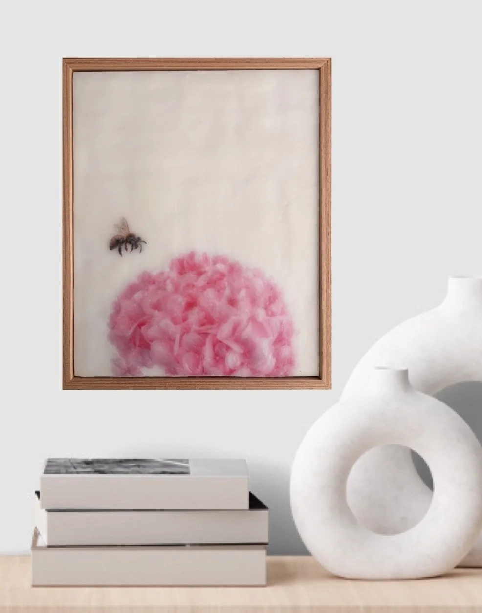 Original encaustic wax artwork of a honeybee hovering beside soft pink hydrangea flowers, framed in Tasmanian oak with a dreamy, luminous botanical finish.