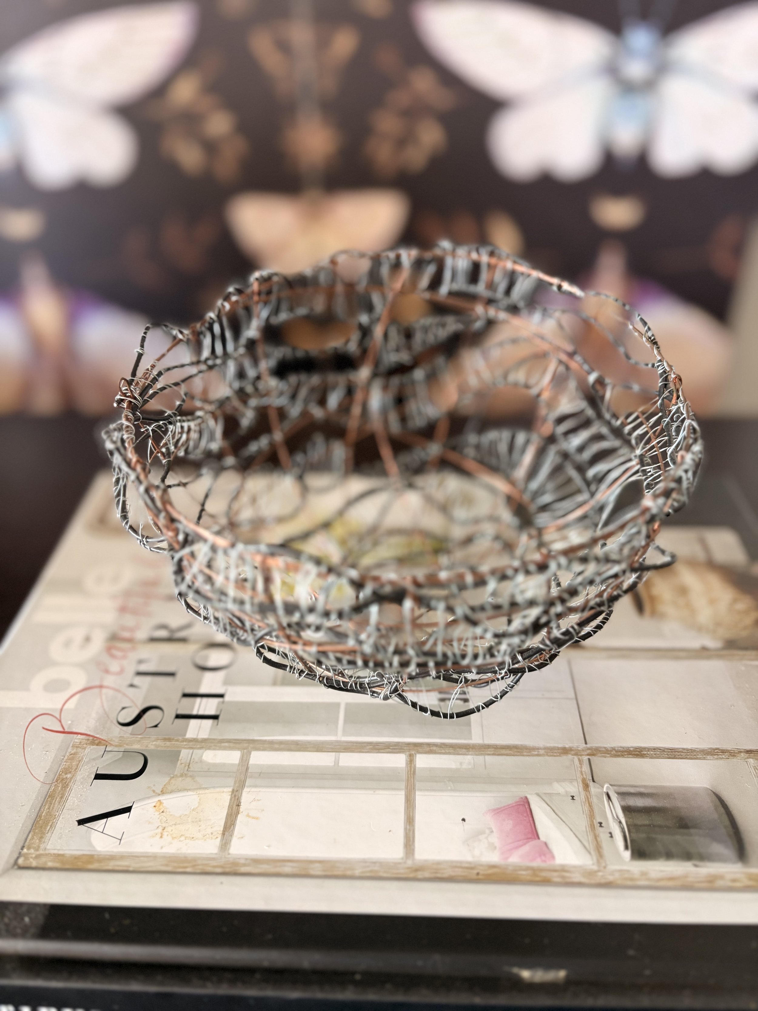 Handcrafted wire sculpture bowl made from copper and steel wire, featuring an organic woven design with layered textures, displayed as a contemporary sculptural vessel.