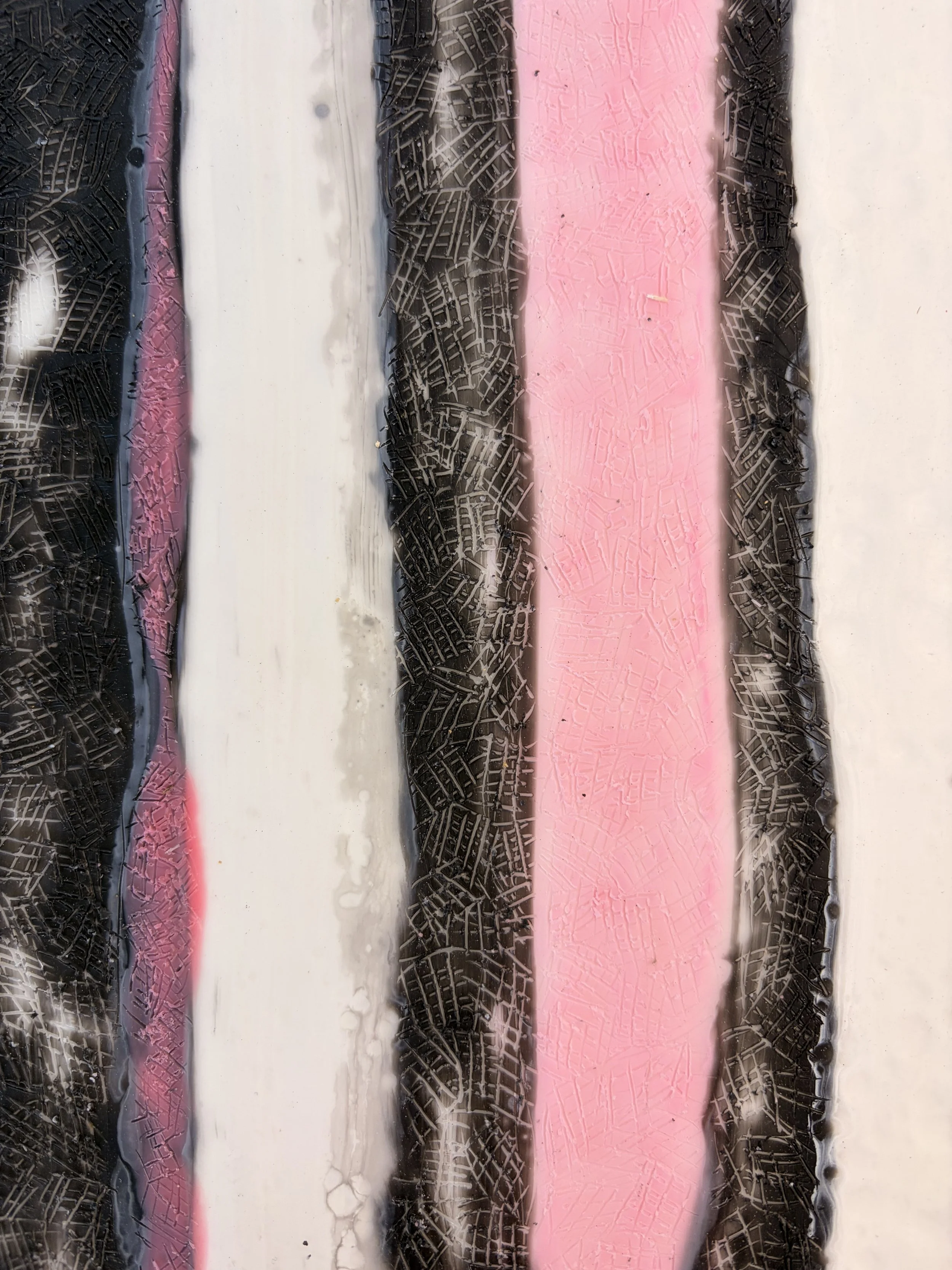 Close-up and full views of a framed encaustic wax artwork featuring vertical pink, black, and white textured stripes, displayed in a timber frame on a light background.